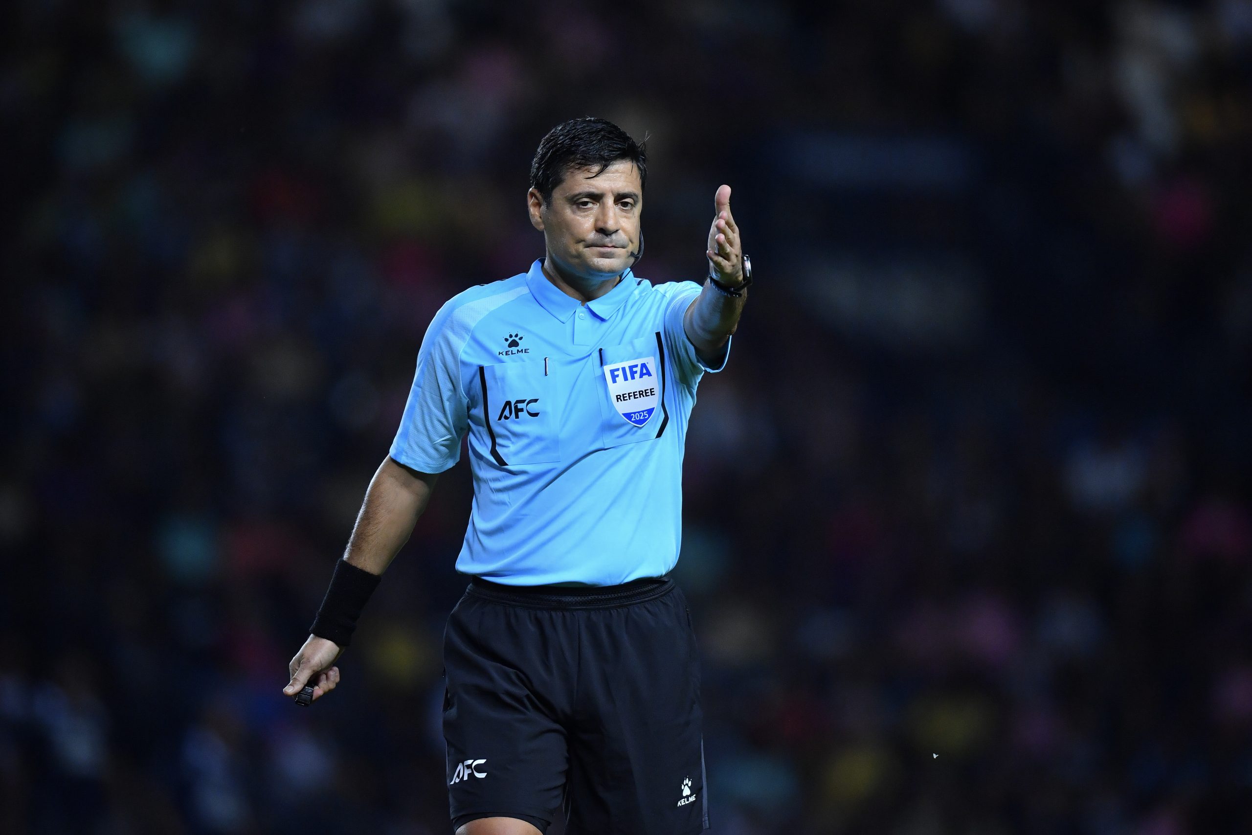 Iranian referee Alireza Faghani in action, representing the AFC at a football match.
