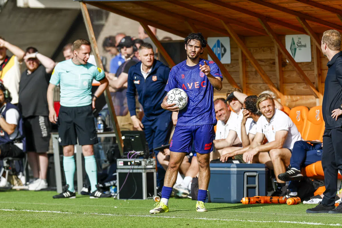 Willem II players celebrating their promotion victory on the field after a penalty shootout.