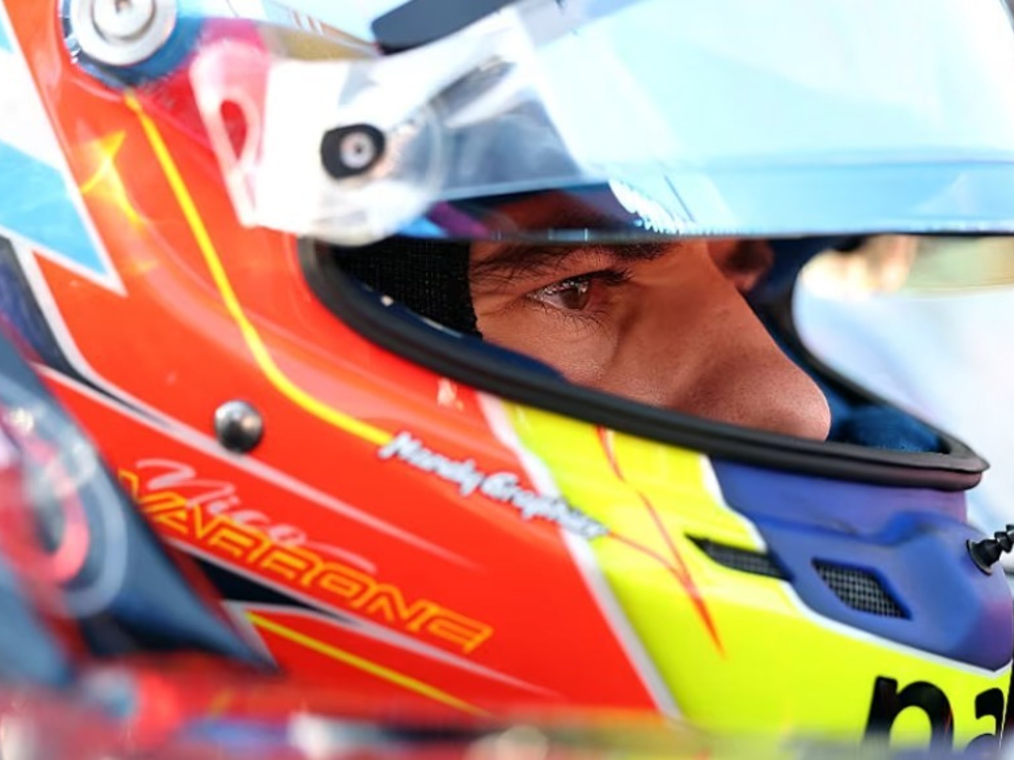 A Formula 2 race car, number 22, driven by Nicolás Varrone, navigating a turn on the Circuit Gilles Villeneuve track in Montreal.