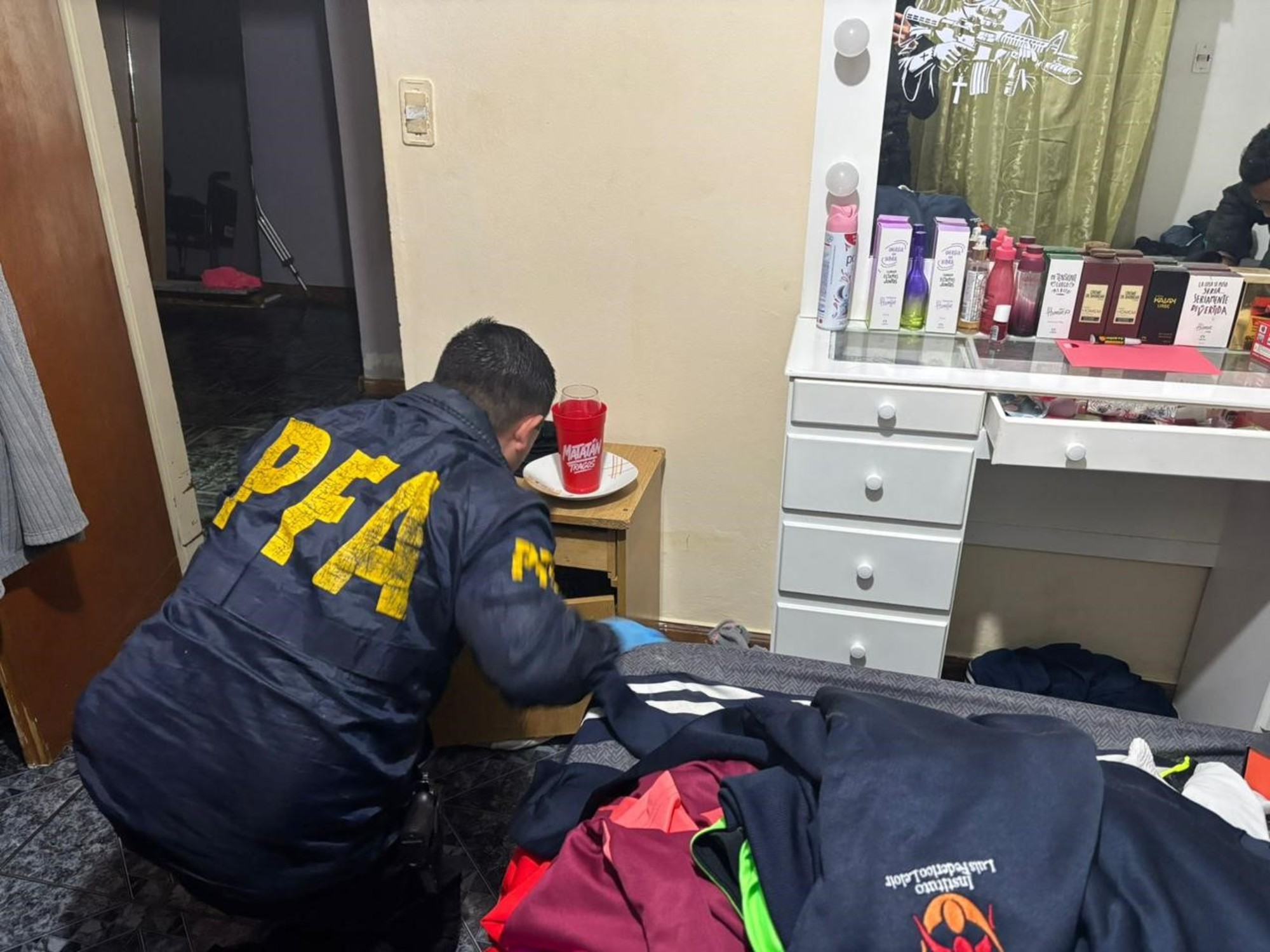 Police officers conducting a search during a drug raid.