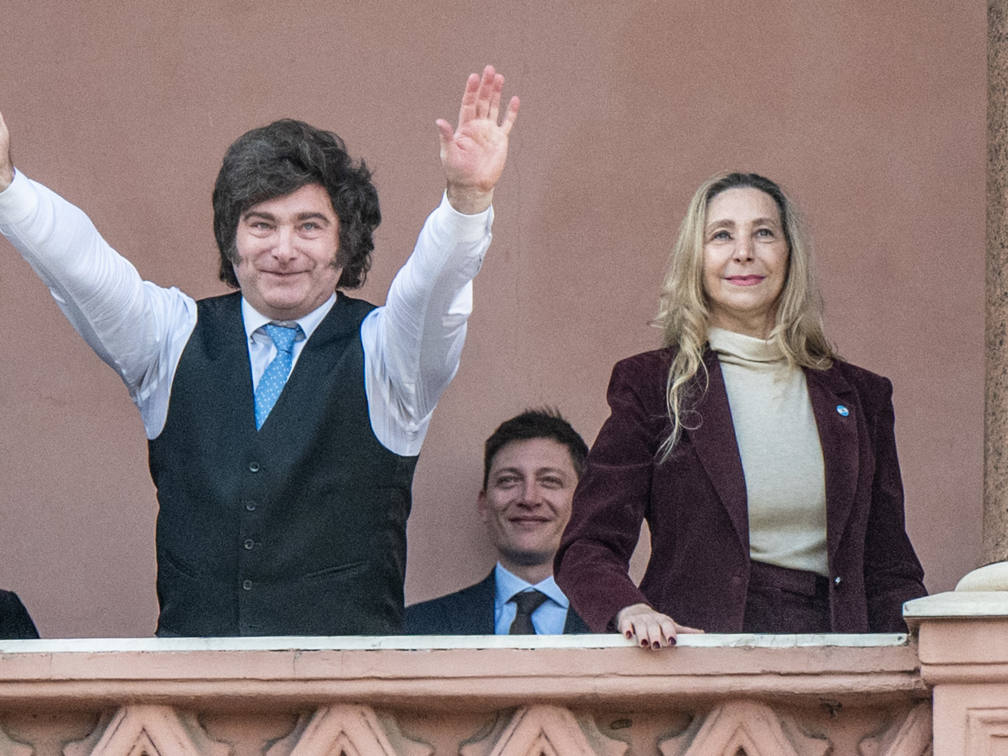 Javier Milei, Karina Milei, and Santiago Caputo pose together on the Casa Rosada balcony.