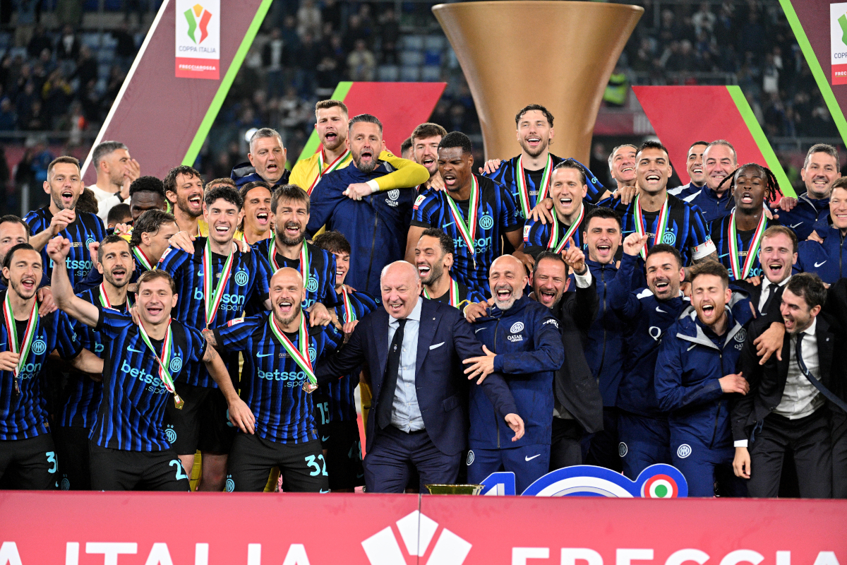 Inter Milan fans with flags and scarves celebrating inside San Siro stadium