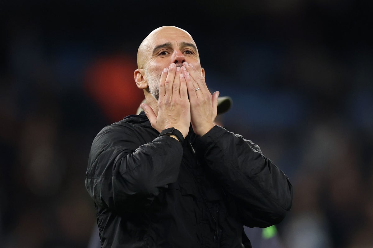 Pep Guardiola celebrating with Manchester City players and trophies
