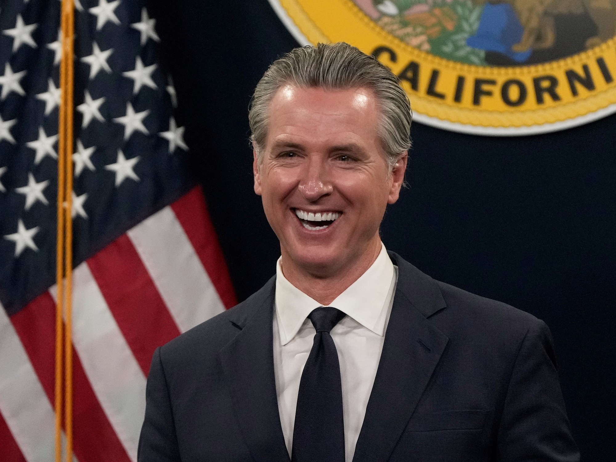 California Governor Gavin Newsom speaking at a press conference about housing policy