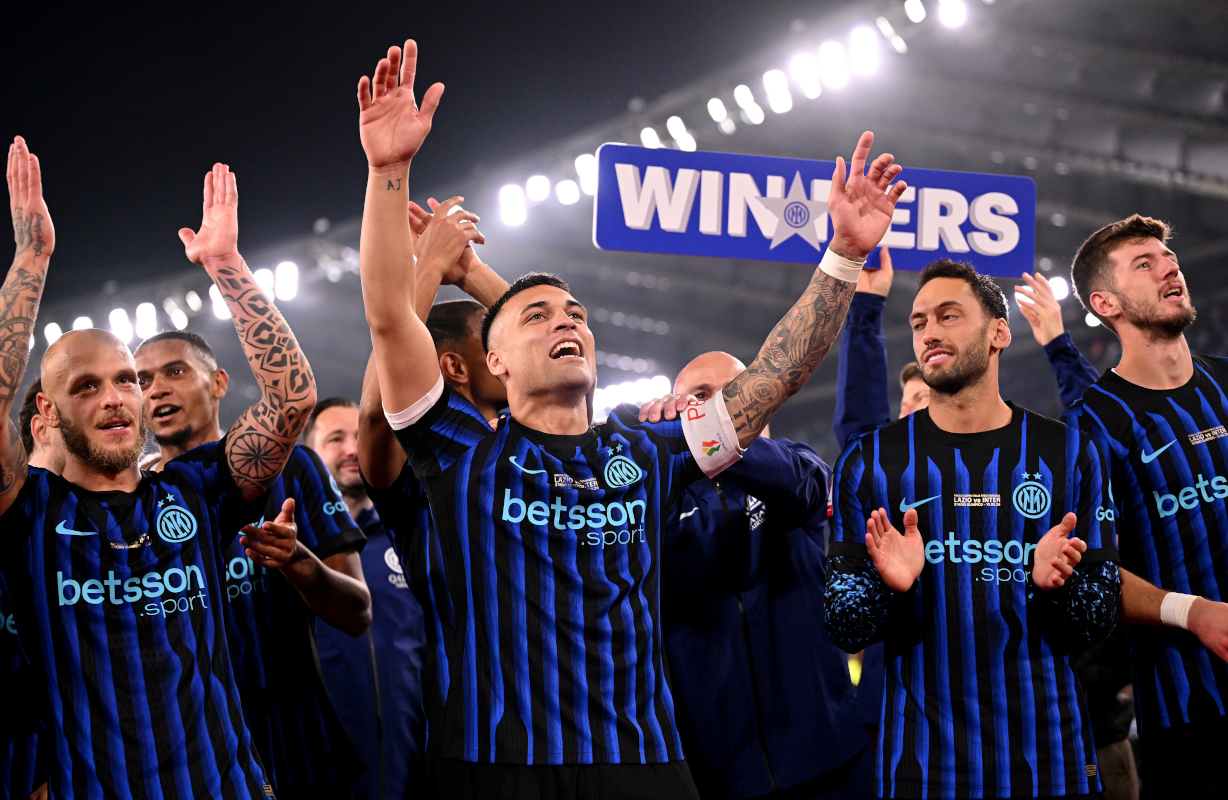 Lautaro Martinez of Inter Milan celebrates with the Coppa Italia trophy.