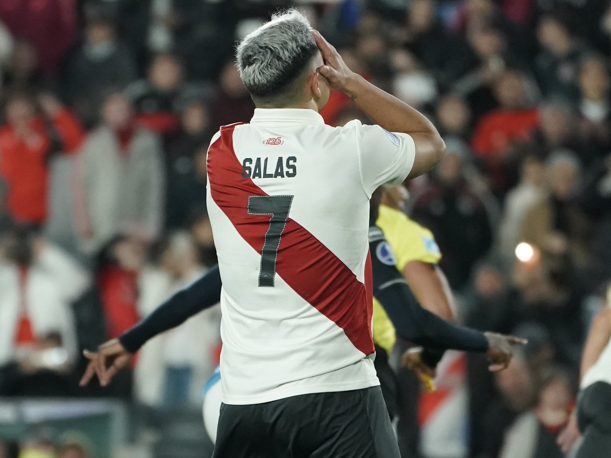 A football player from River Plate taking a penalty kick during a match.