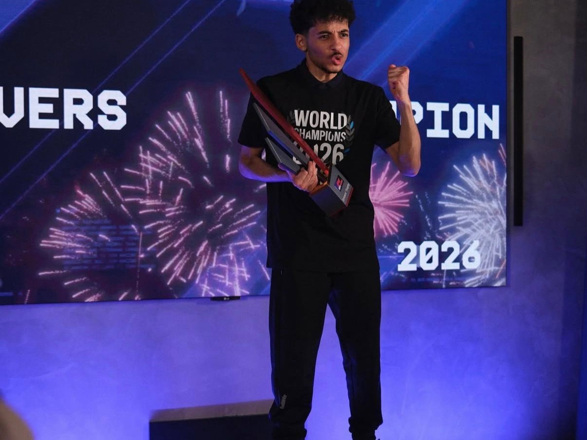 Otis Lawrence holding the F1 Sim Racing World Championship trophy