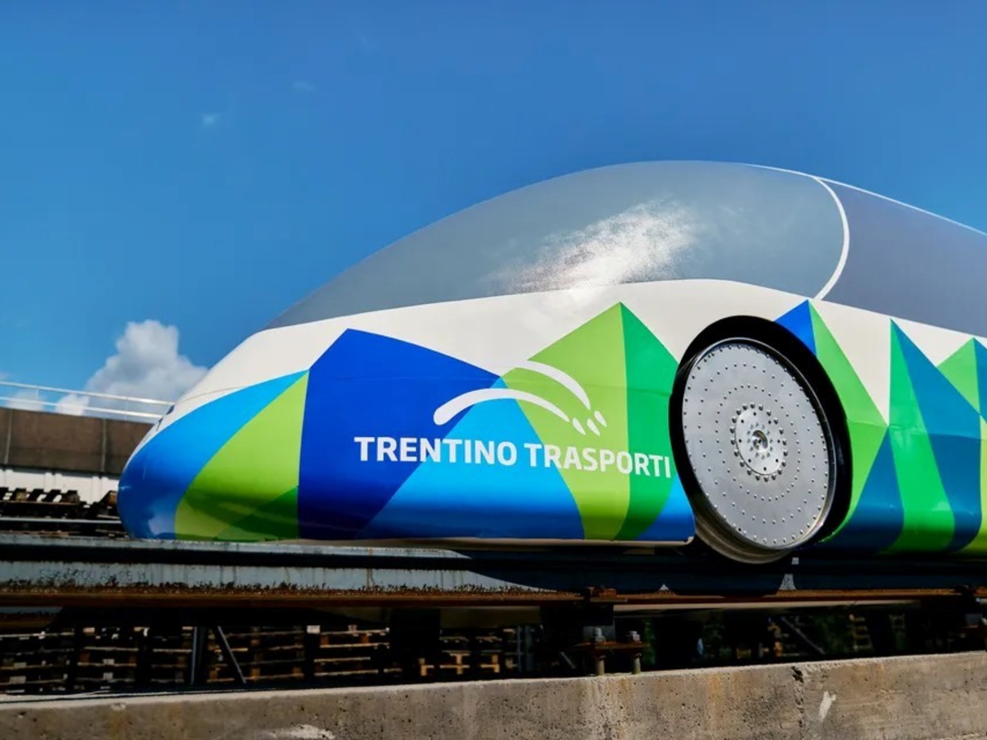 A modern, compact vehicle designed to operate on railway tracks, representing the concept of an autonomous railway taxi.
