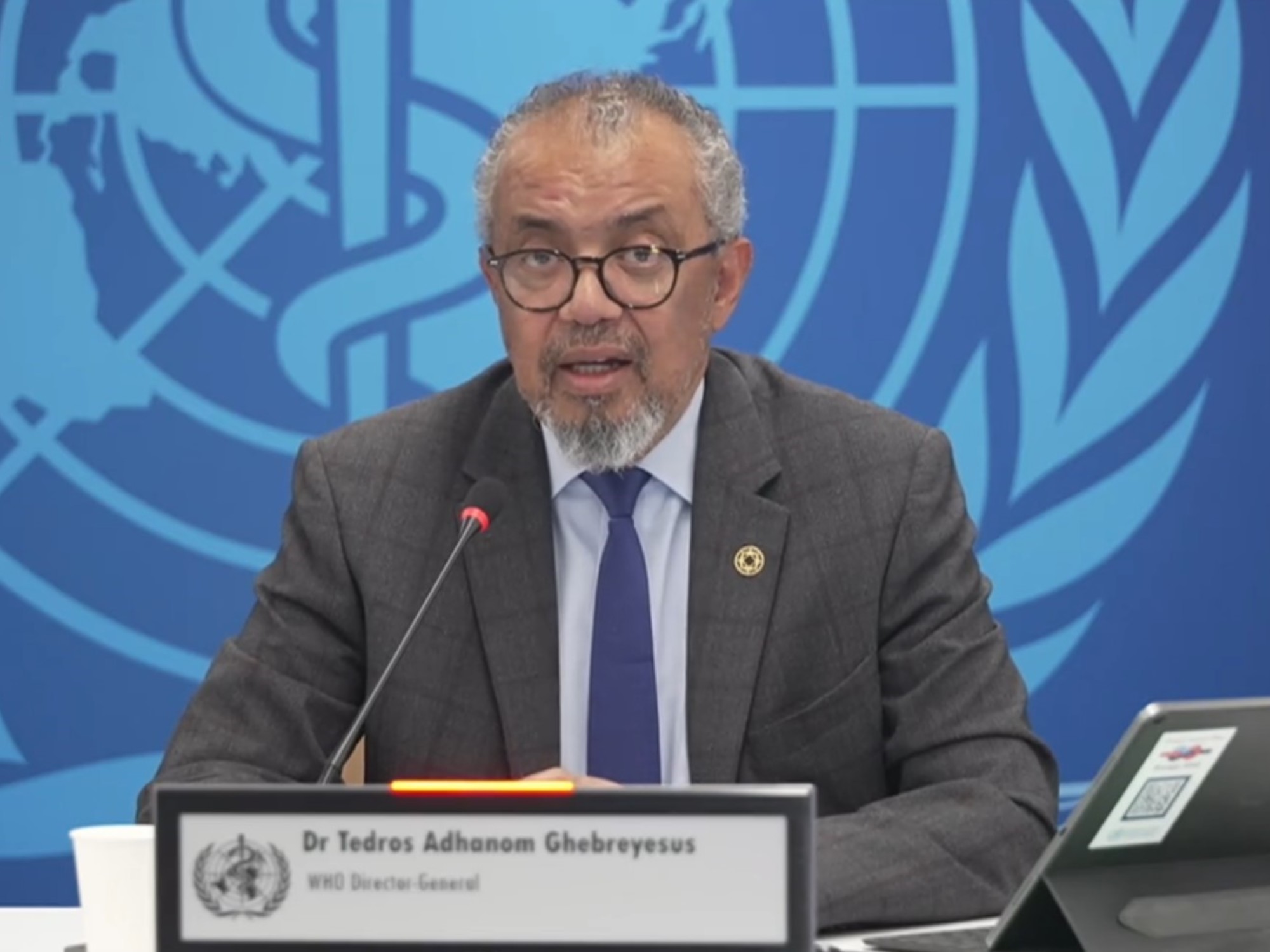 Argentina flag partially dissolving into the World Health Organization logo