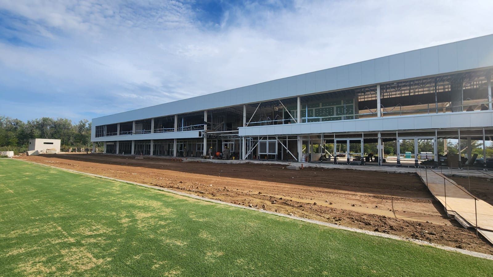 Members of the Racing Club squad touring the construction site of their new training complex in Ezeiza.