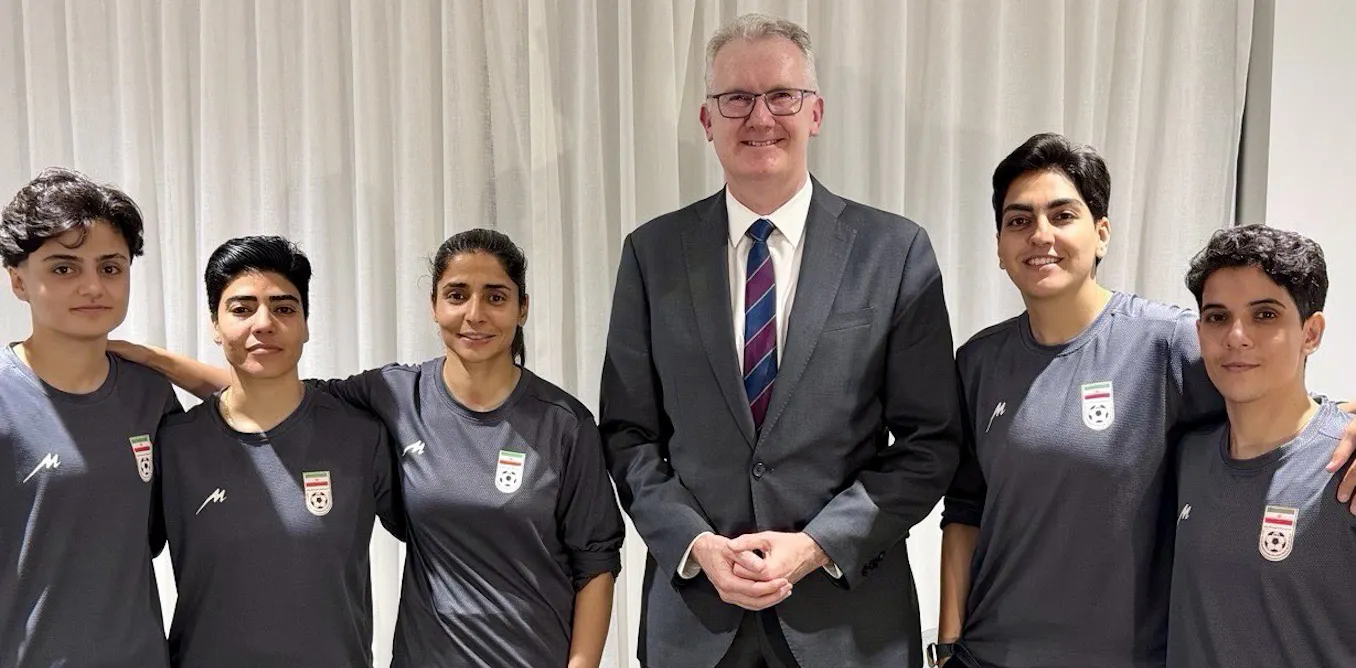 Five Iranian women's soccer players alongside Australian Minister for Home Affairs Tony Burke at a Gold Coast location after being granted humanitarian visas.