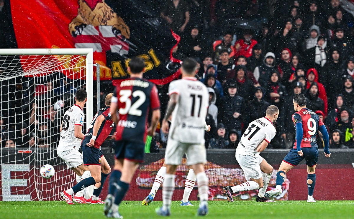 AC Milan player dribbles past a Genoa defender during a Serie A match