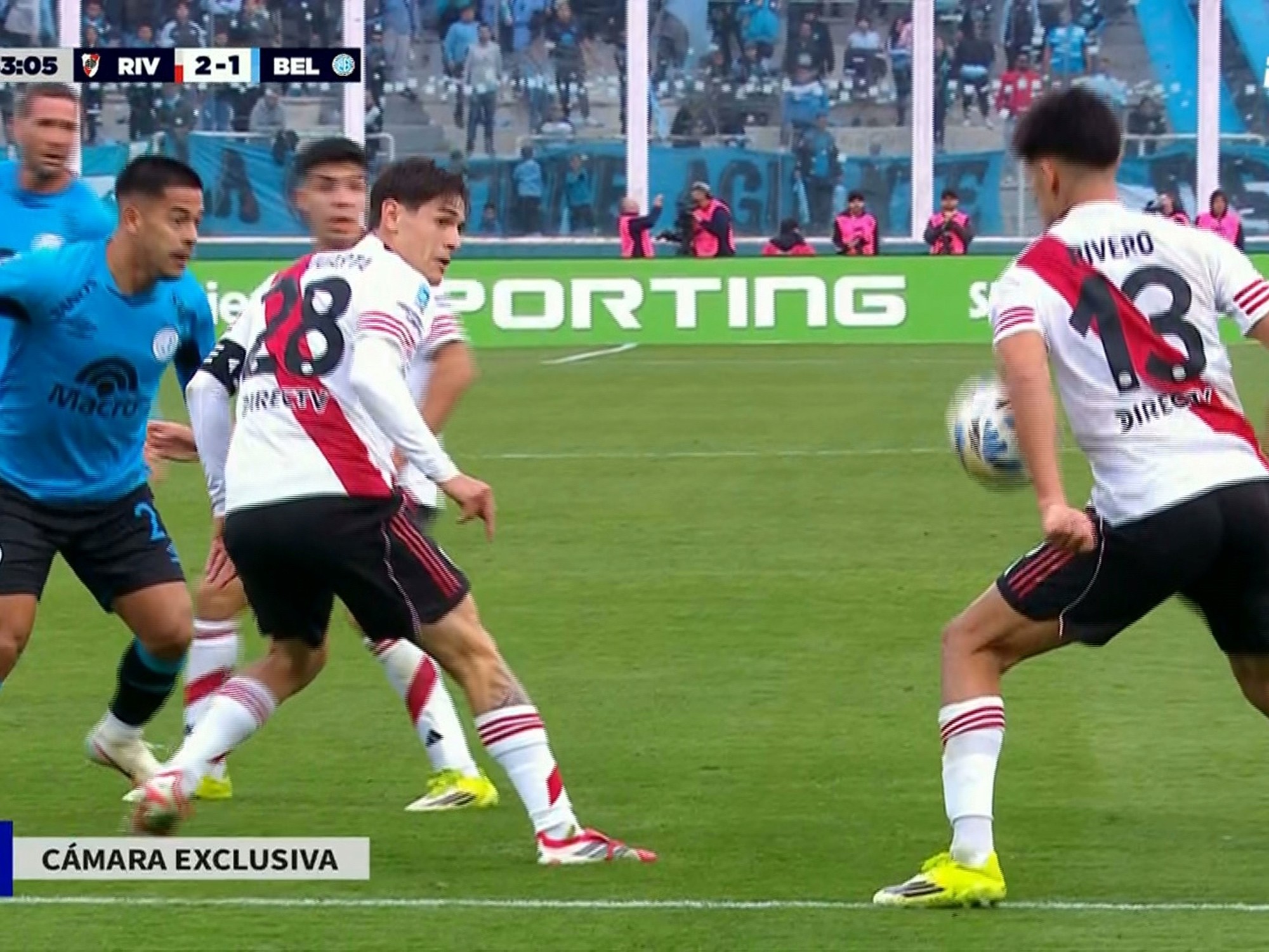 Referee reviewing a penalty incident on the VAR screen during a football match between River Plate and Belgrano.
