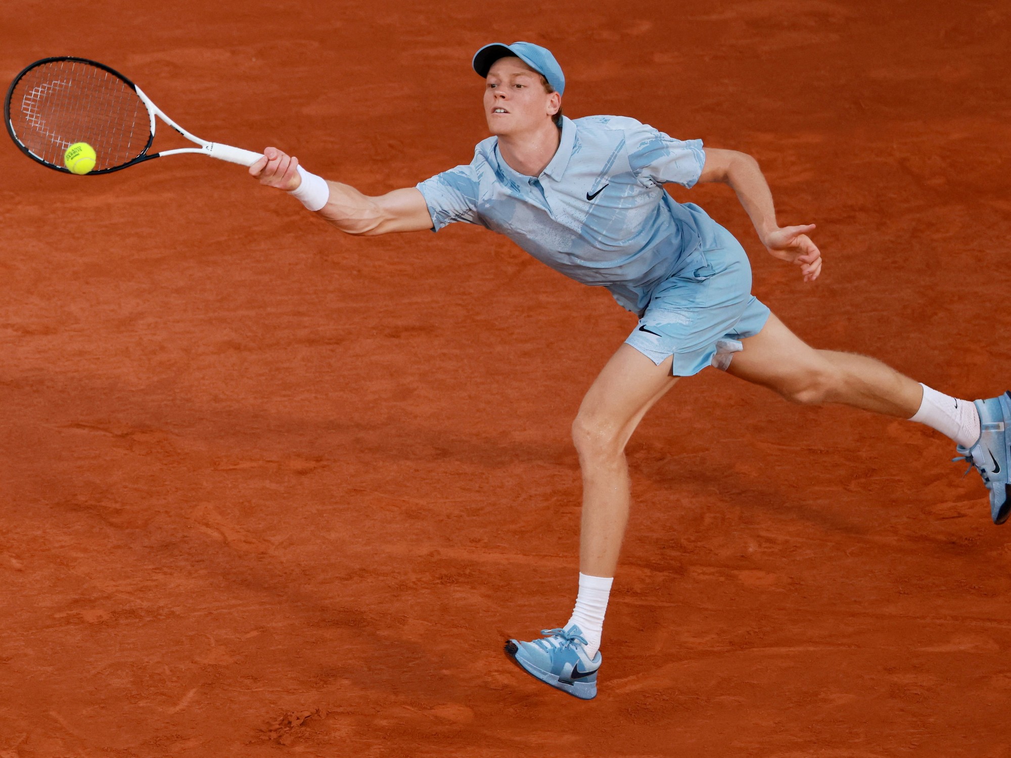 Jannik Sinner in action on a tennis court