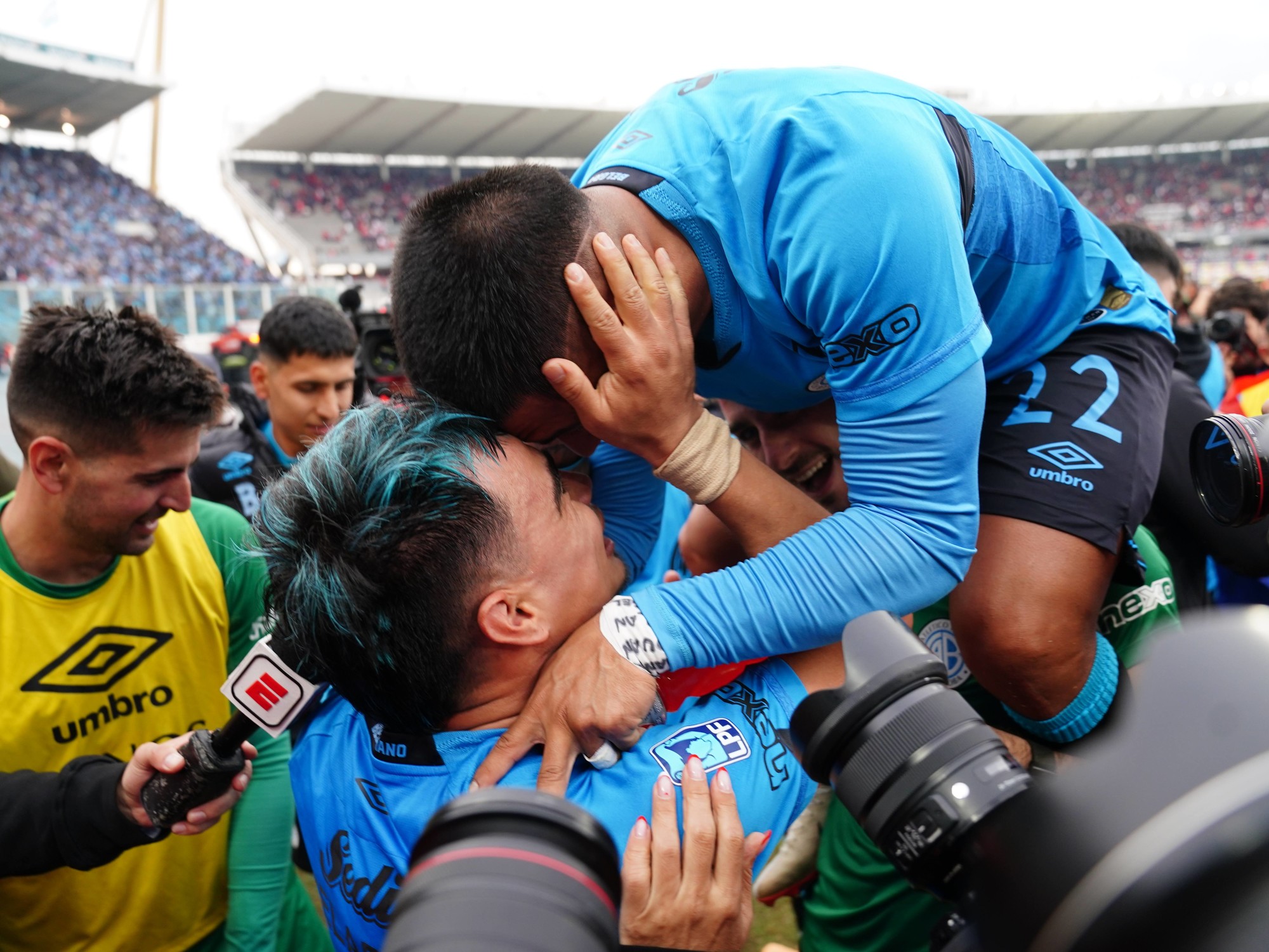 Belgrano players celebrating their hard-fought Apertura championship victory.