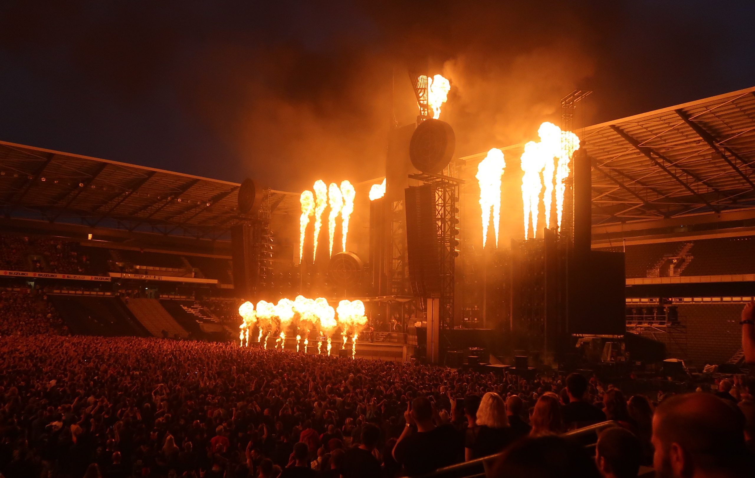 Shakira performing live in front of a large audience during a concert.