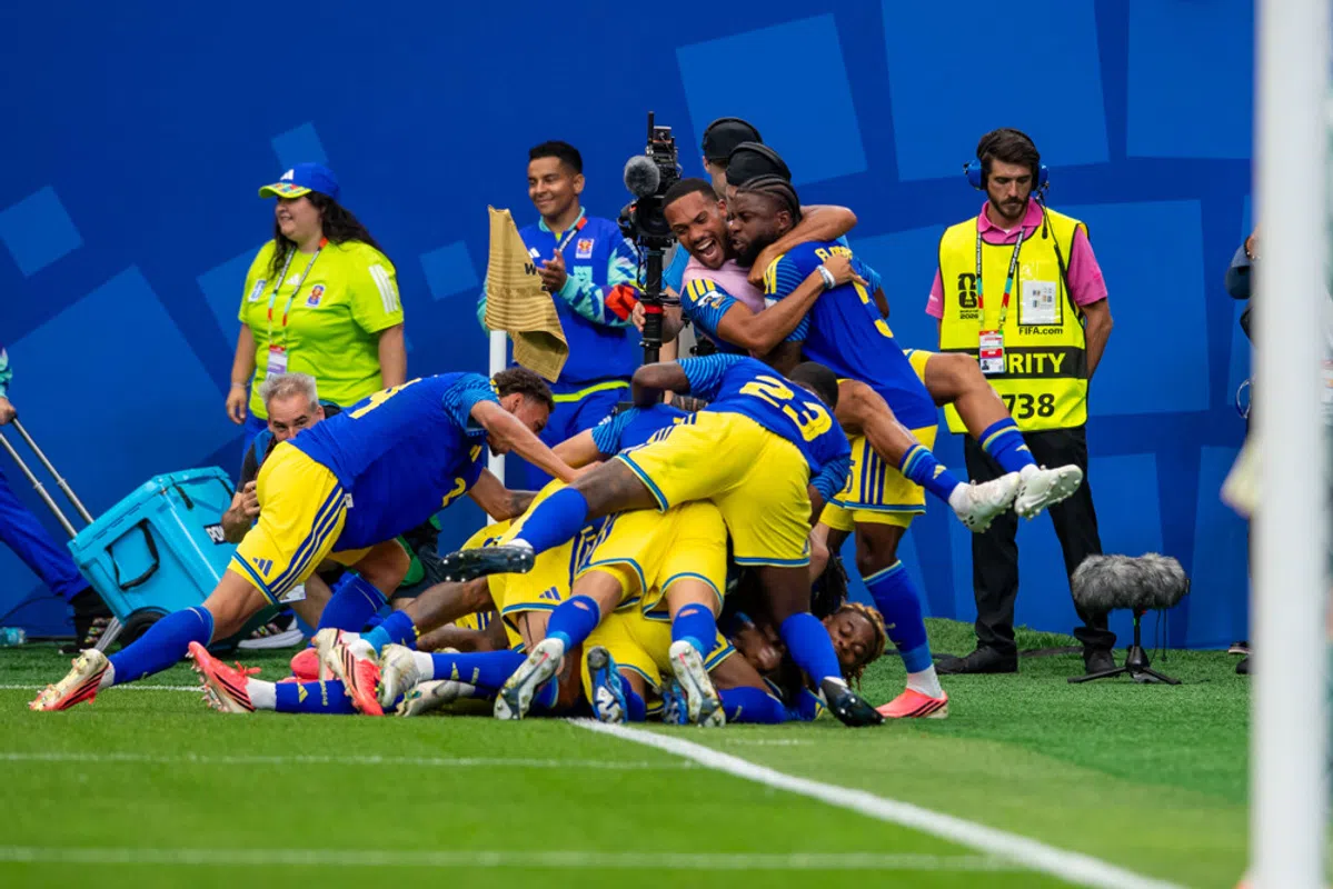 Curaçao national football team celebrating a goal during a match.