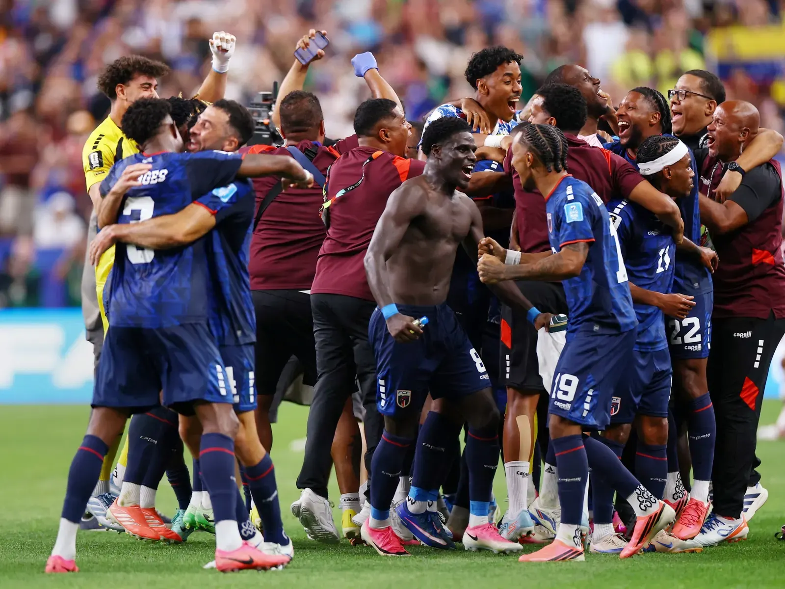 Cabo Verde national football team players celebrating on the field during a match.