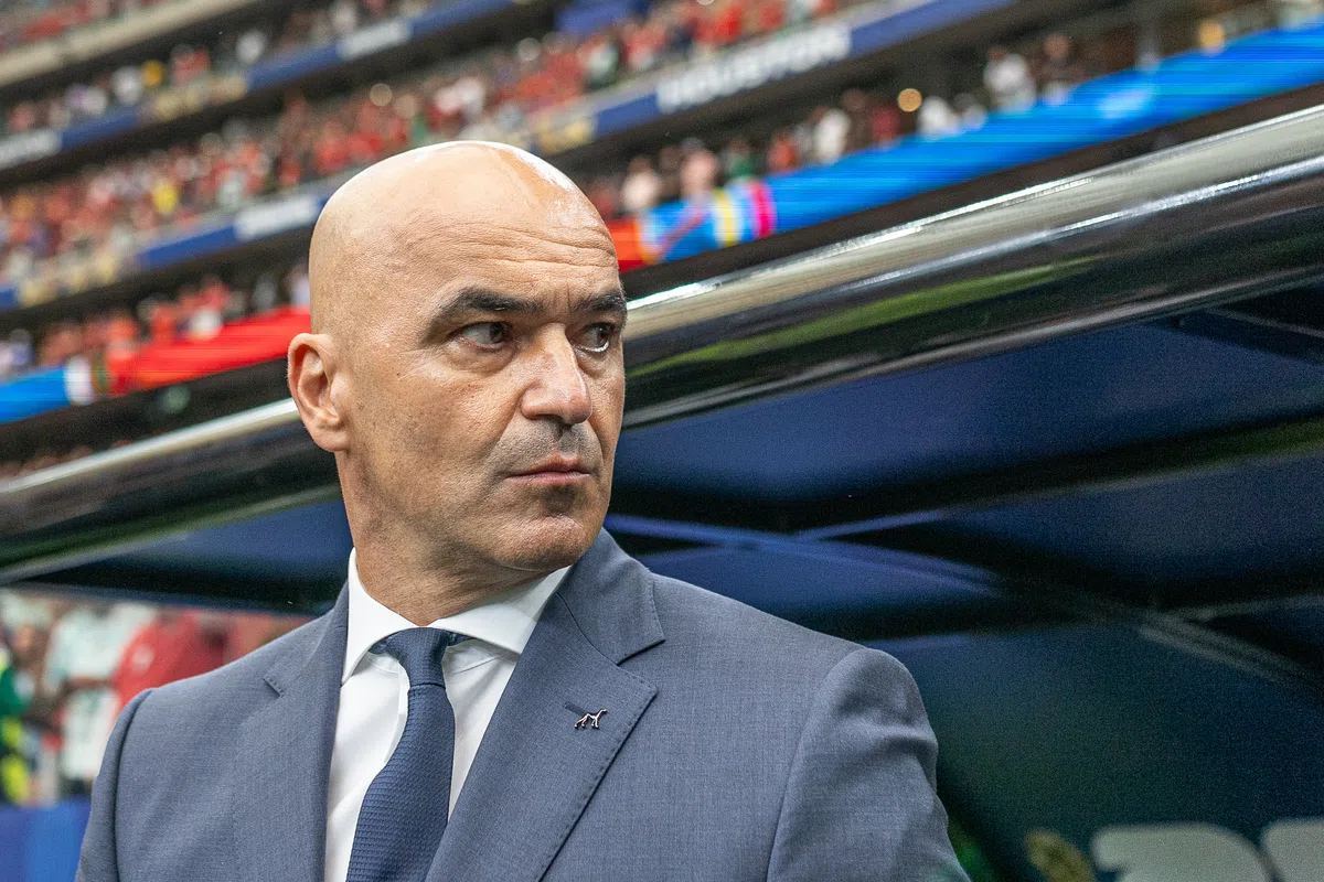 Roberto Martínez, the head coach of the Portugal national team, seen in discussion on the sidelines during a football match.
