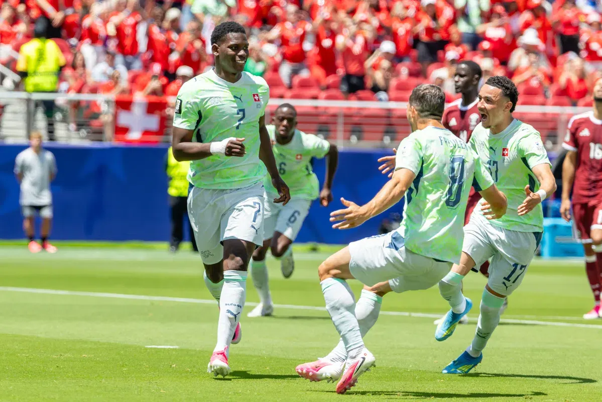 Football players celebrating a goal during a 2026 FIFA World Cup match.