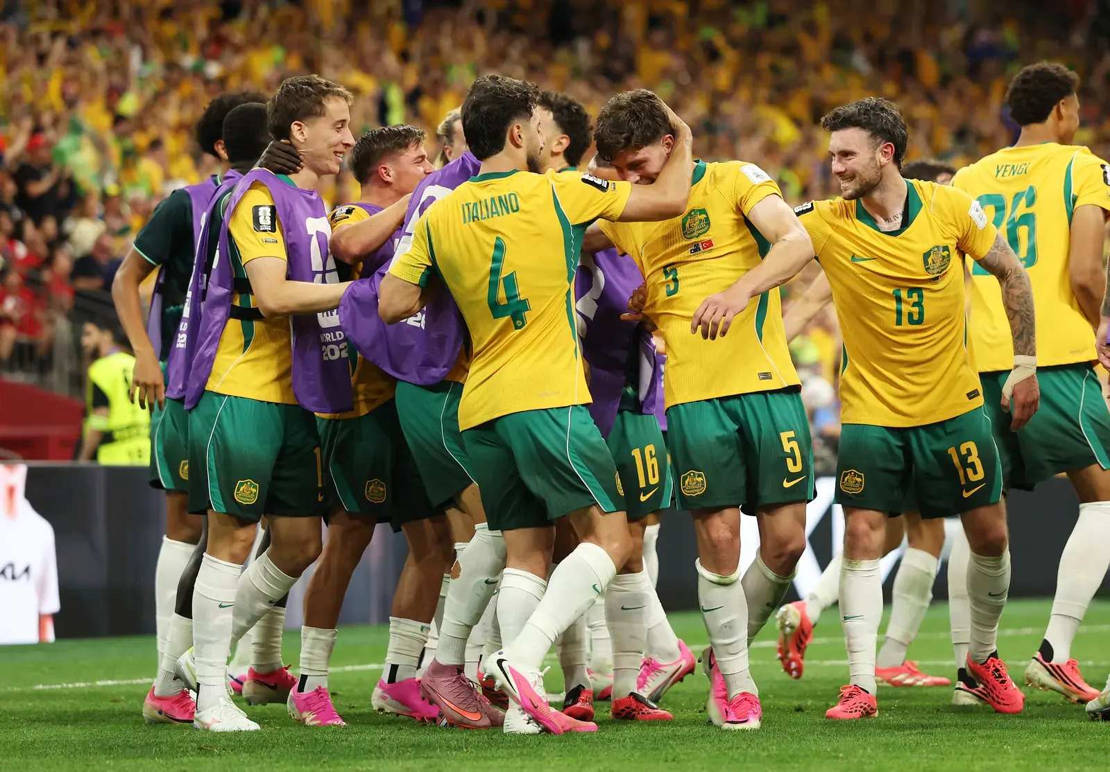 Australia national football team players celebrating a goal during a FIFA World Cup match.