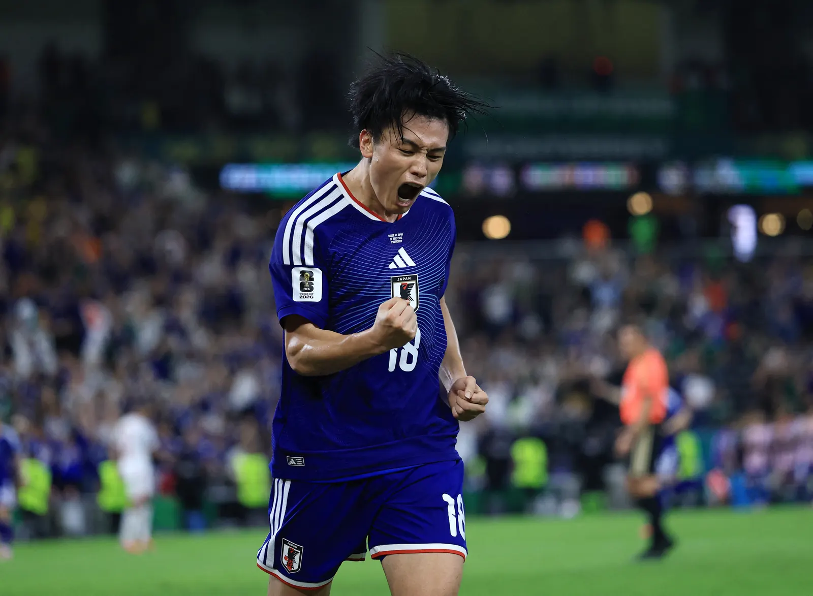Ayase Ueda celebrates scoring a goal for Japan in the FIFA World Cup.