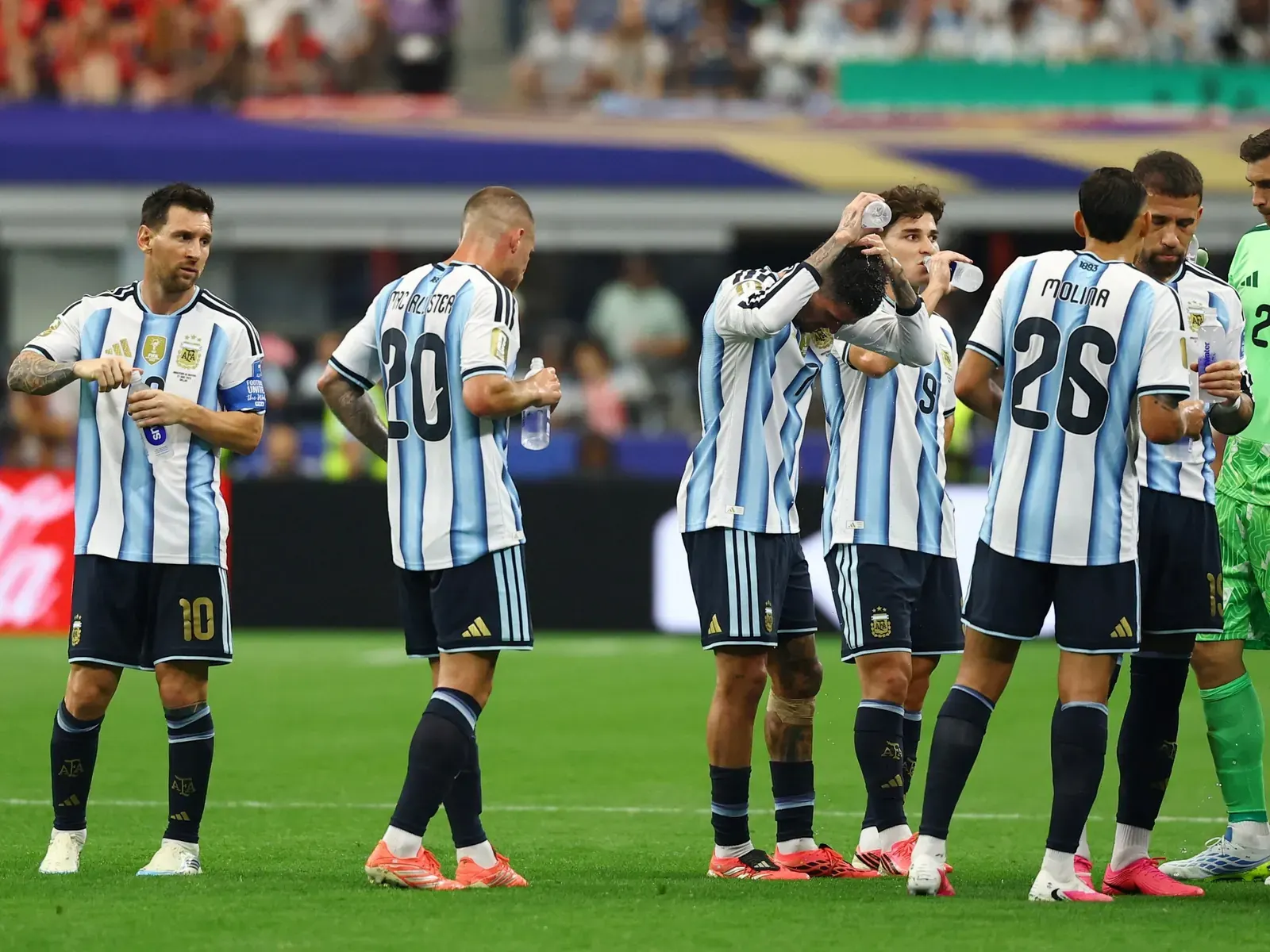 A wide shot of a modern football stadium during the FIFA World Cup 2026, with players on the pitch.