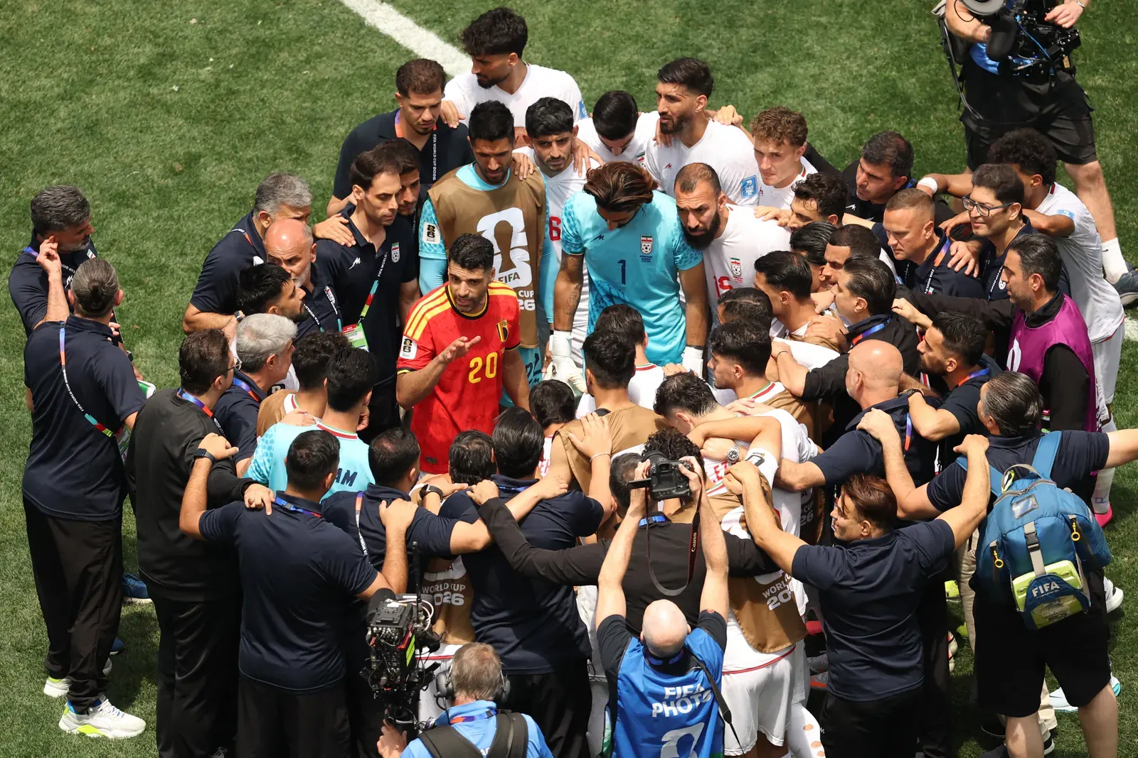 IR Iran national football team players celebrating a goal during a match.