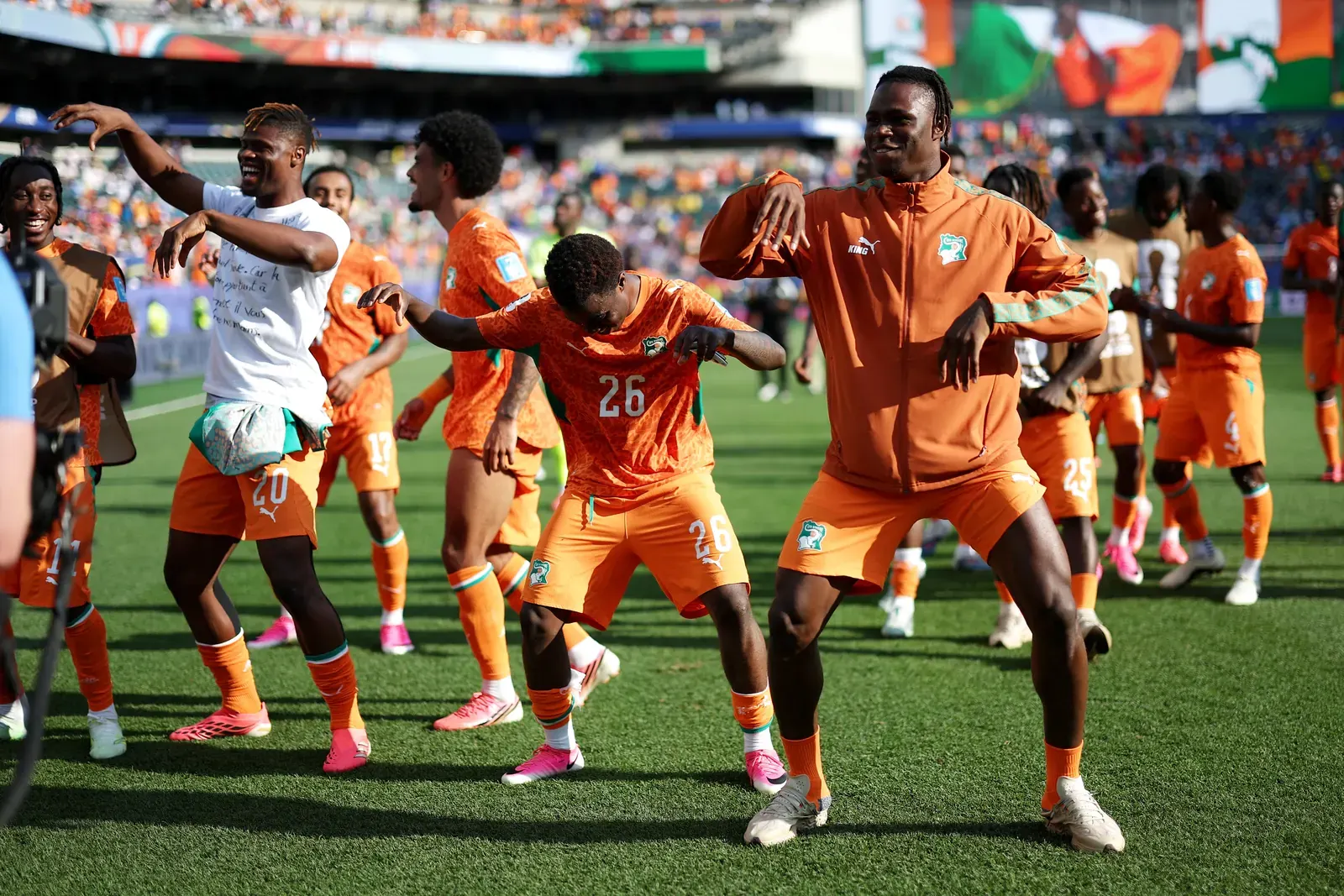 Cote d'Ivoire players celebrate reaching the FIFA World Cup knockout stage.