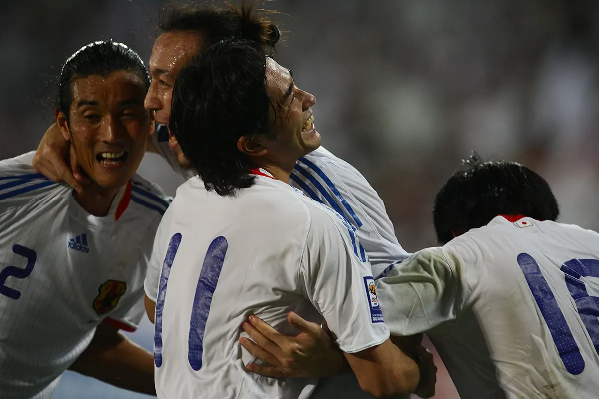 Japan national football team players celebrate a goal during a match