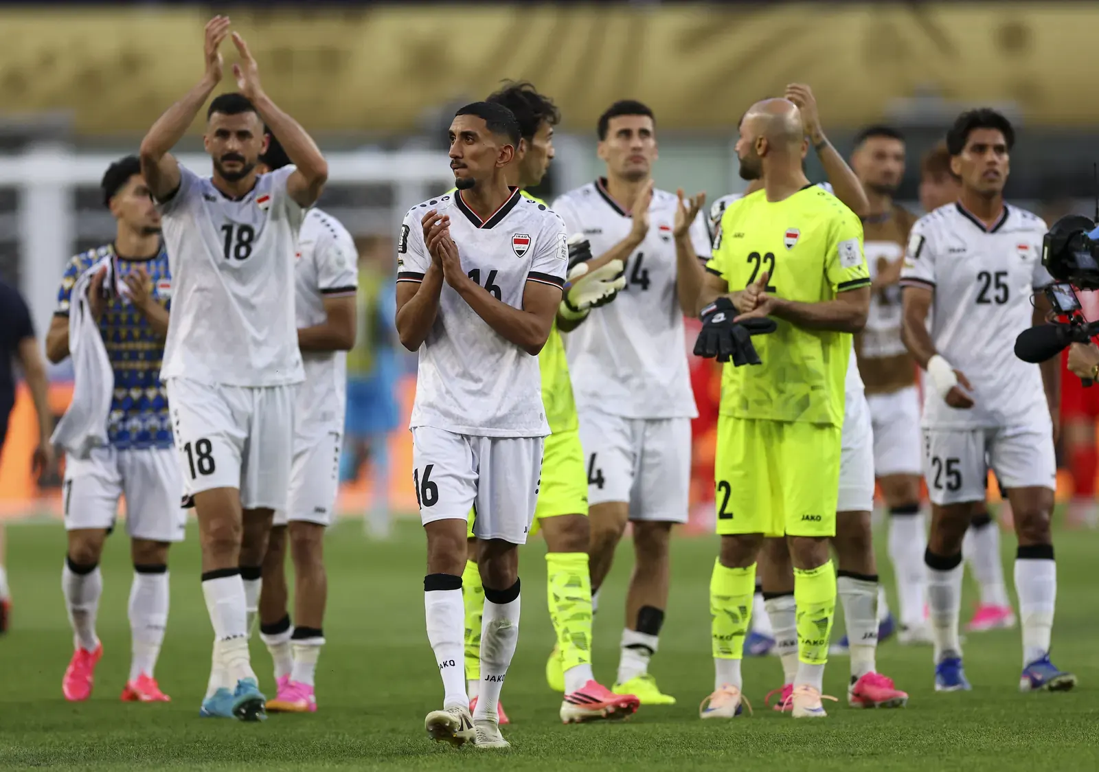 Players from the French and Iraqi national football teams in action during a FIFA World Cup match.