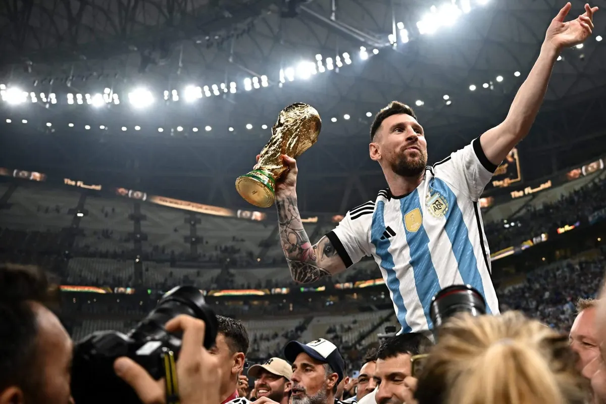 A stylized image of the FIFA World Cup trophy surrounded by a variety of national flags, representing the global nature of the tournament.