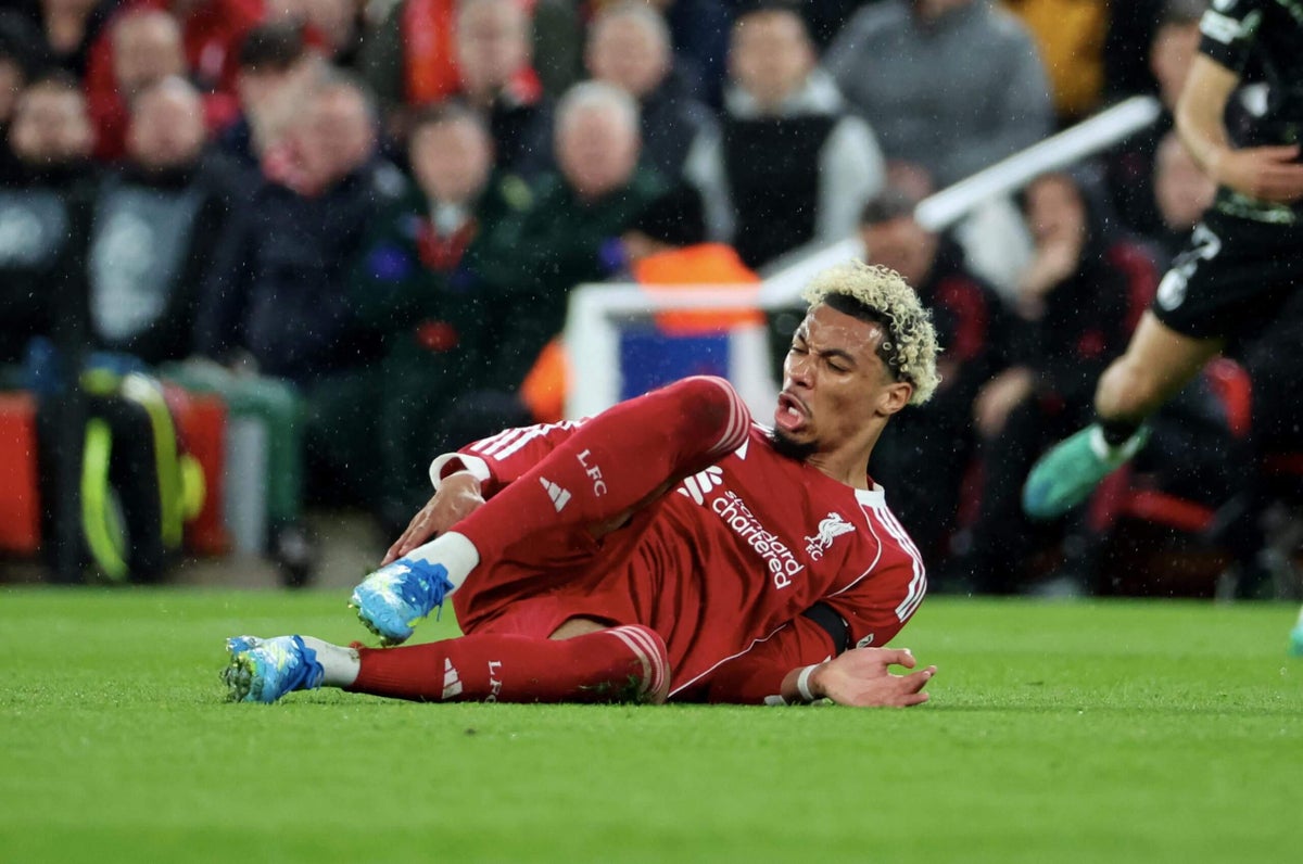Football player being attended to by medical staff on the pitch after an injury