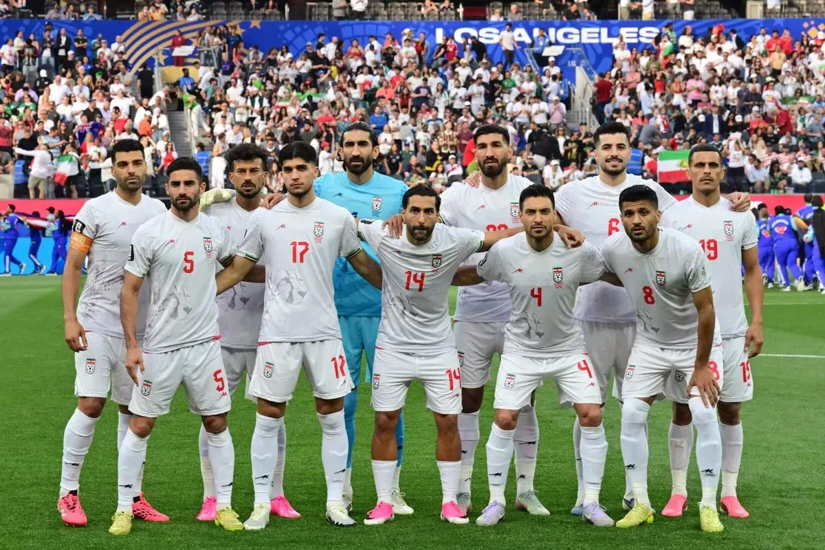 Fans display pre-revolutionary Iranian flags in the crowd at the World Cup match.