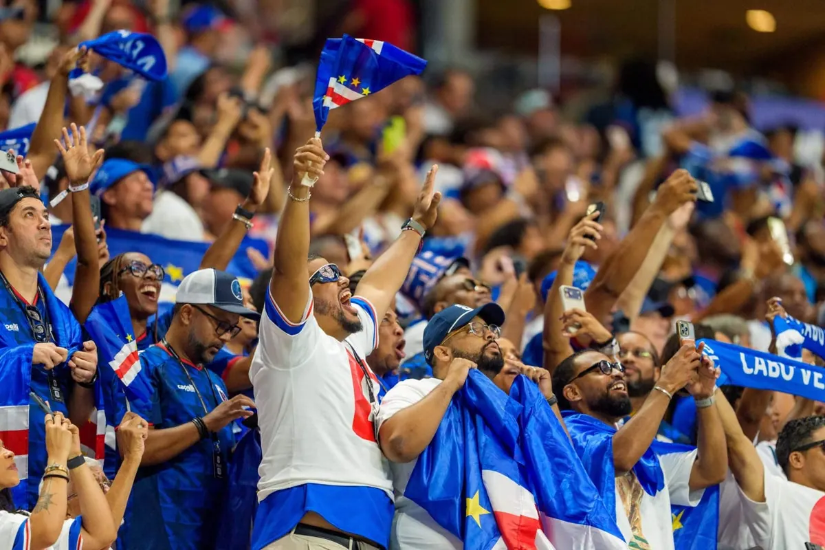 A football player from Cape Verde defends against a Spanish attacker during a World Cup match.