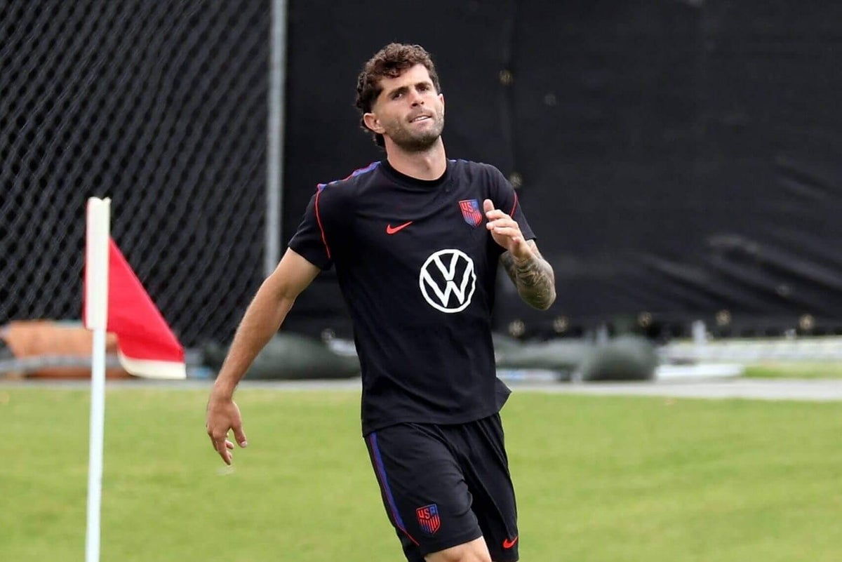 USMNT star Christian Pulisic in training gear, wearing a compression sleeve on his left calf.