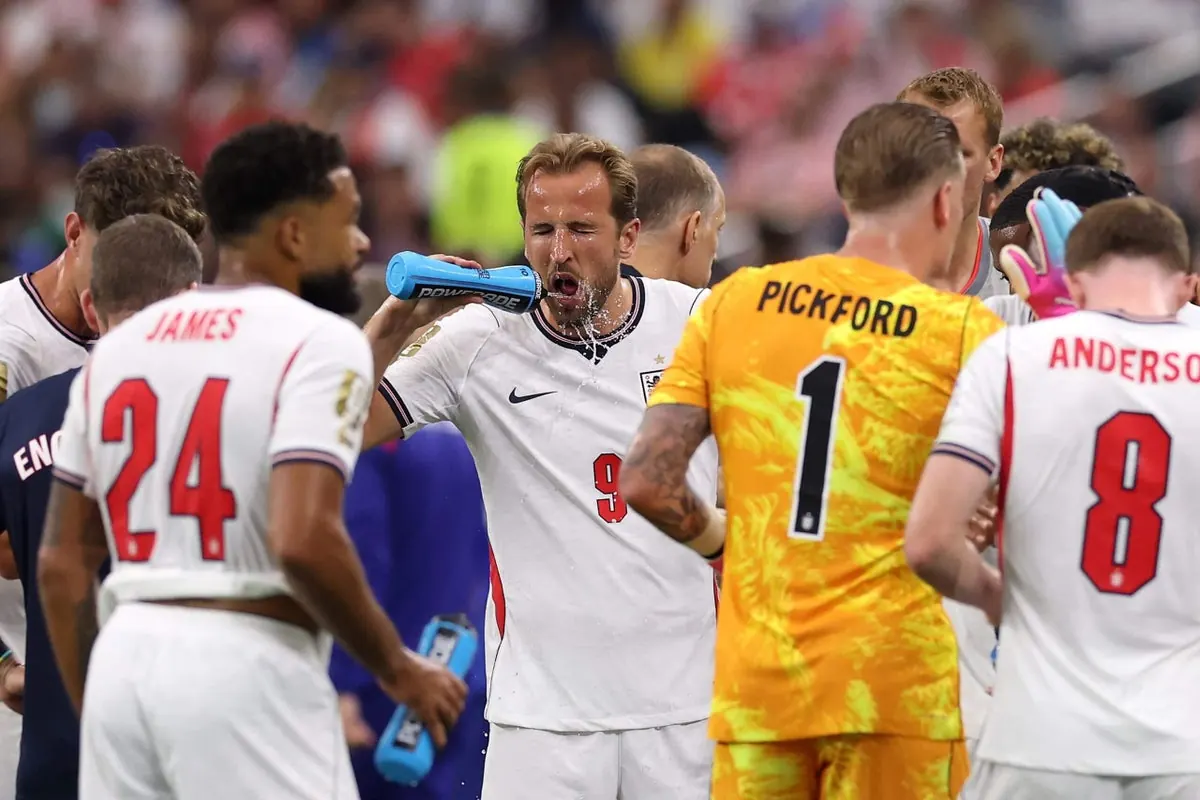 England players practicing drills under a hot and humid sky during World Cup 2026 training.