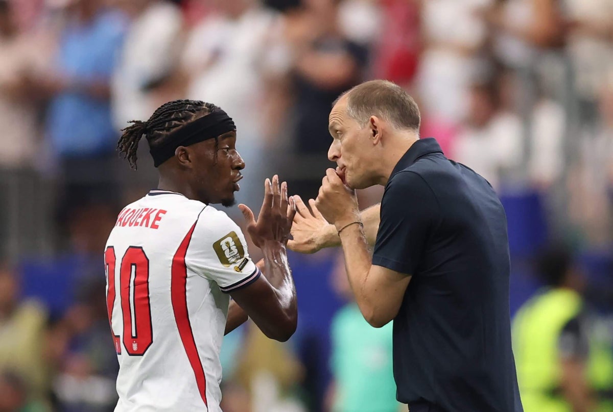 Thomas Tuchel gesturing while speaking to England players in a locker room