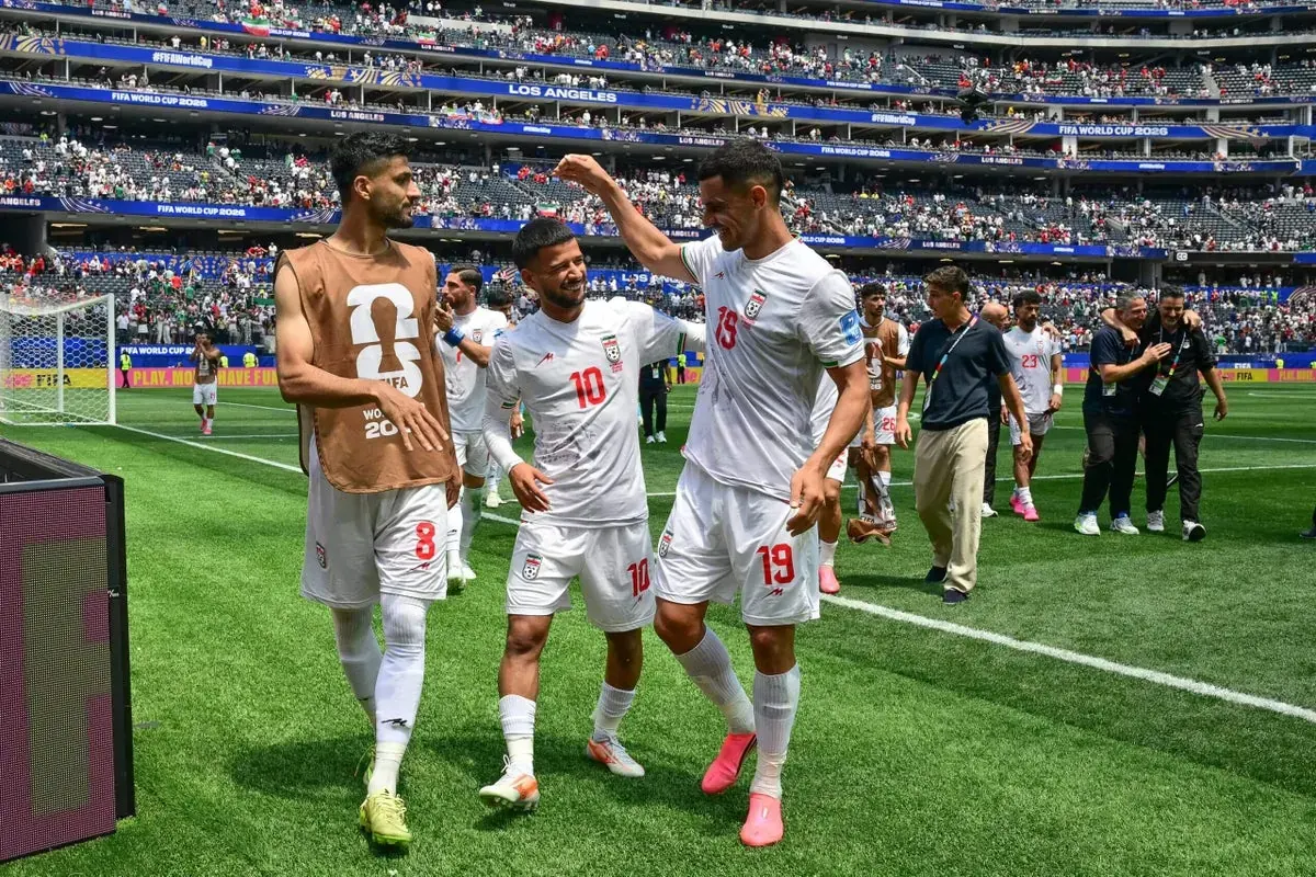 Members of the Iran national football team celebrating a goal during a FIFA World Cup match.