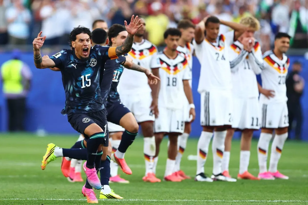 Paraguay players celebrate a penalty kick against Germany during a World Cup match.