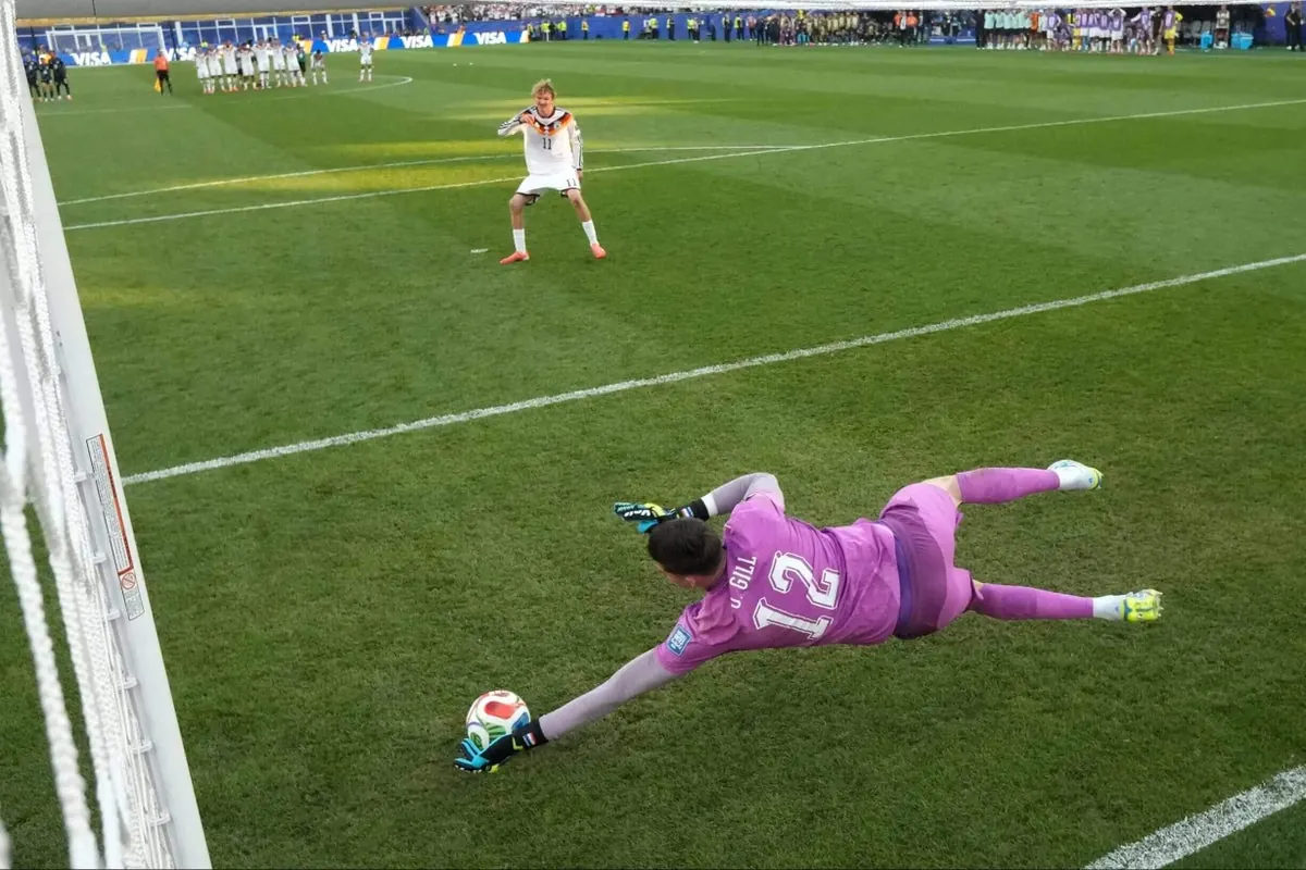 A football player prepares to take a penalty kick during a shootout.