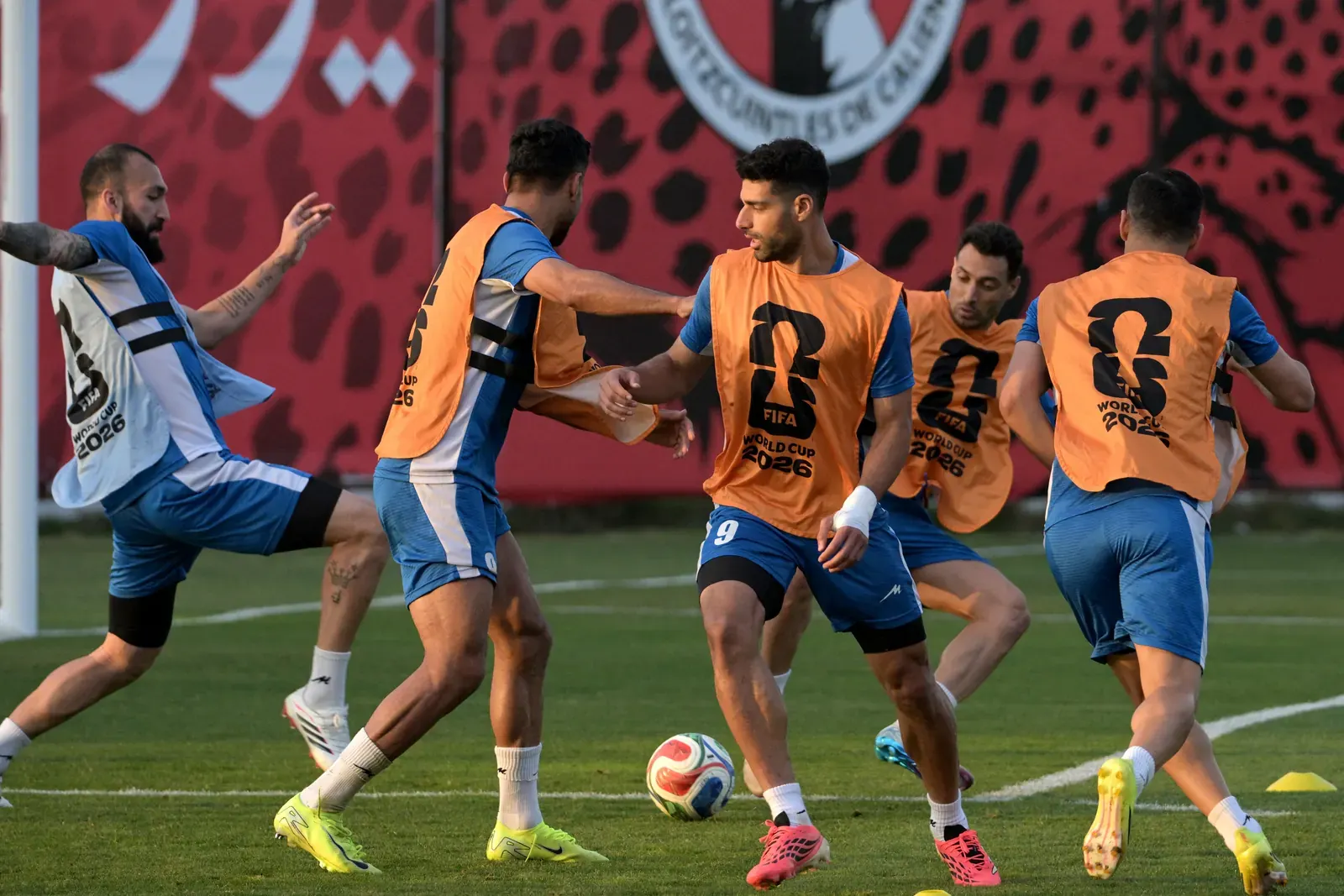 Football players from Egypt and Iran in action during a FIFA World Cup match.