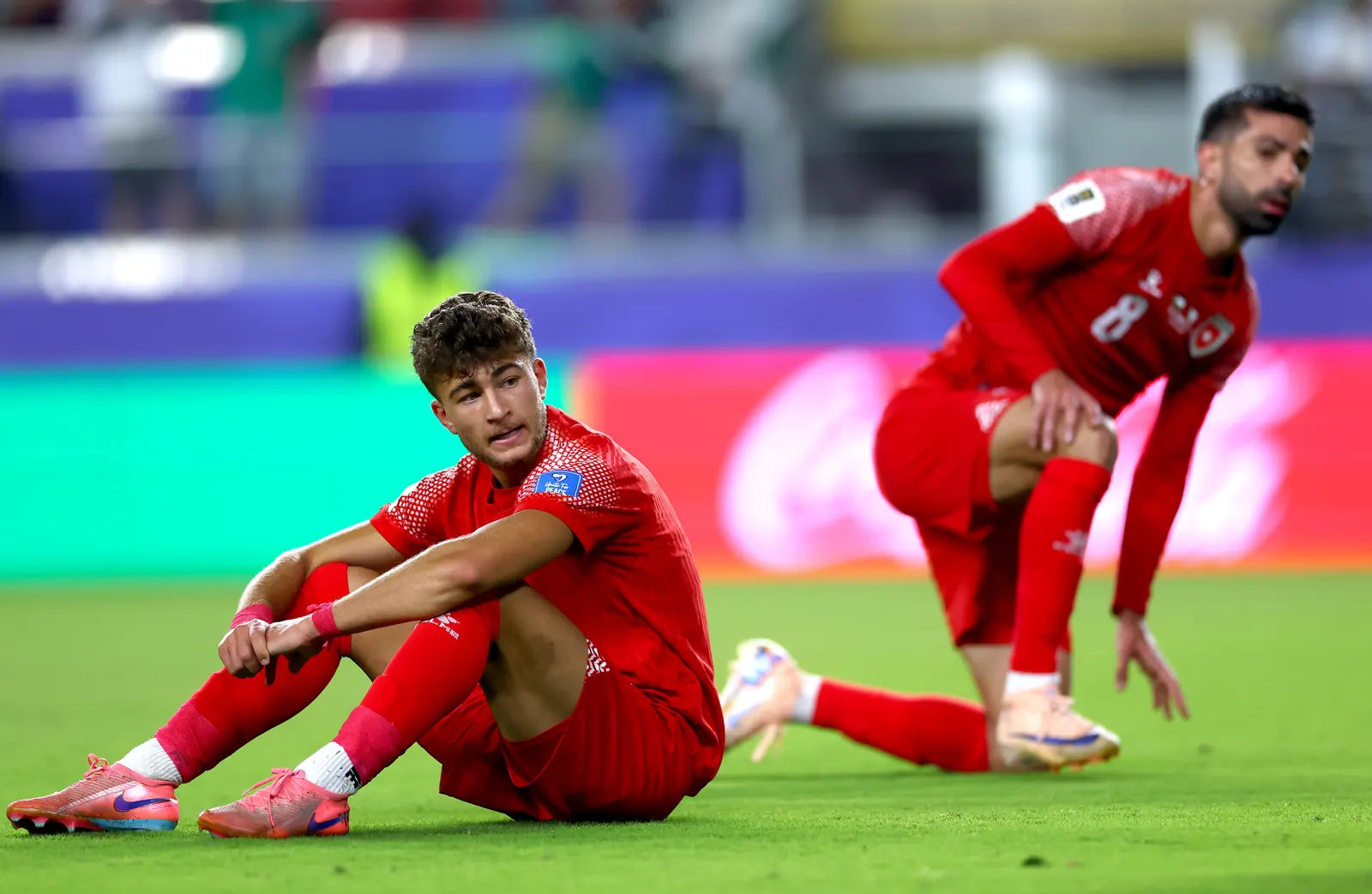 Jordan national football team players celebrating a goal during a match.