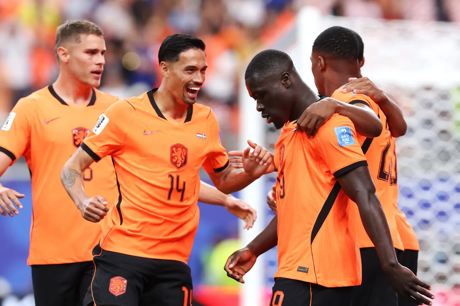 Netherlands players celebrating a goal during their match against Tunisia.