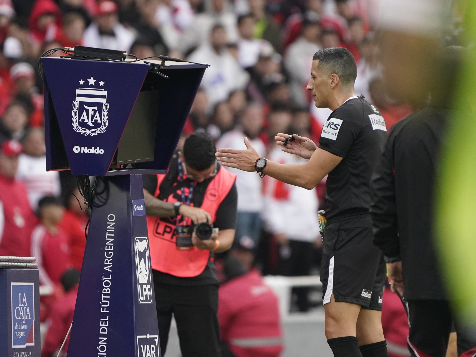 A VAR official monitoring a match from the control room