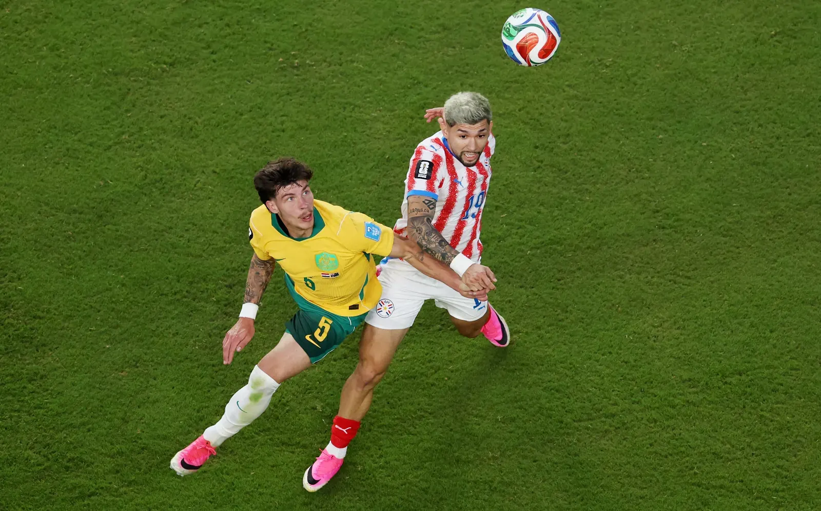 Australian player challenges for the ball against Paraguay during their FIFA World Cup 2026 group stage match.