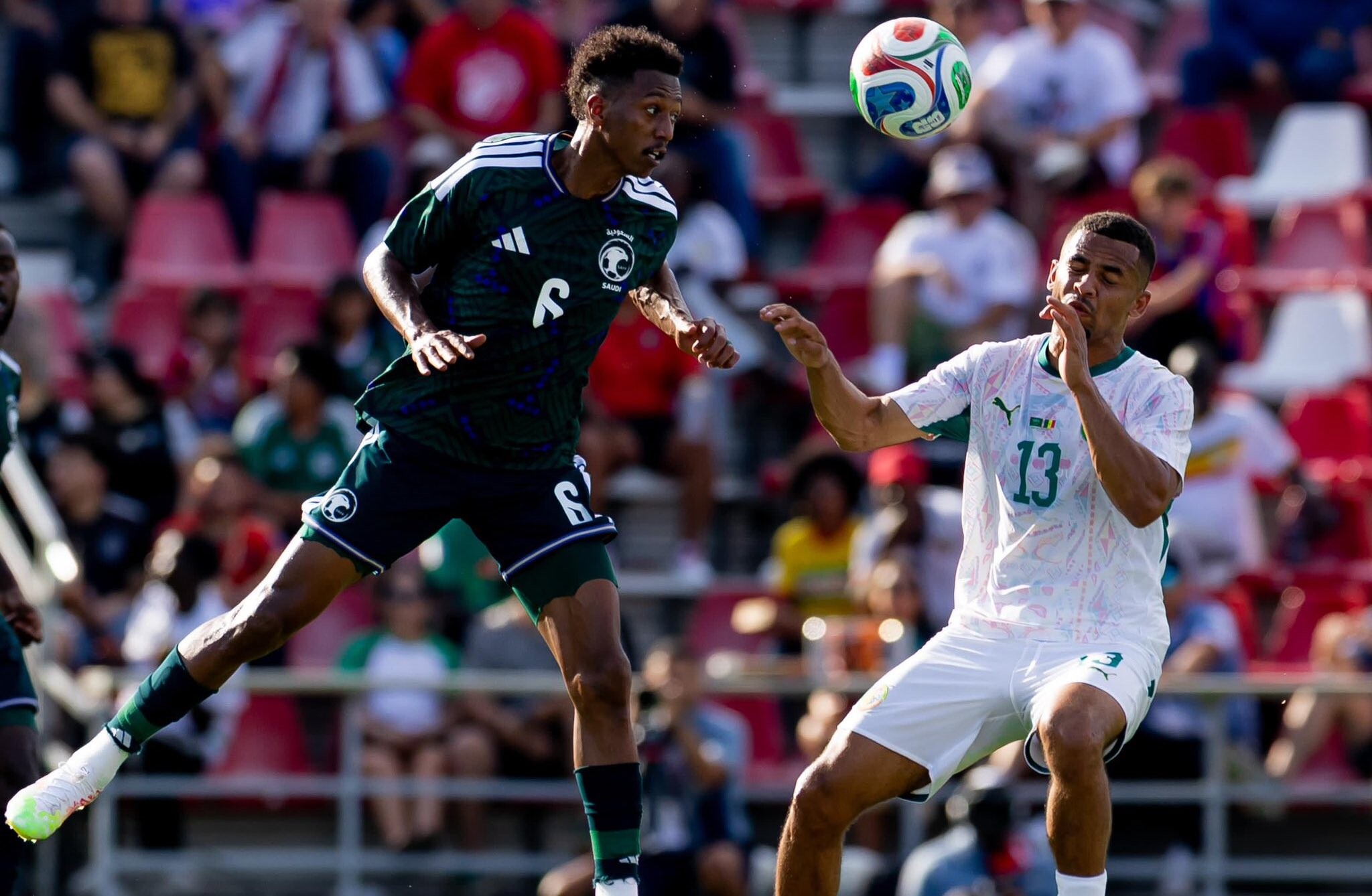 Saudi Arabia national football team in action during an international match.