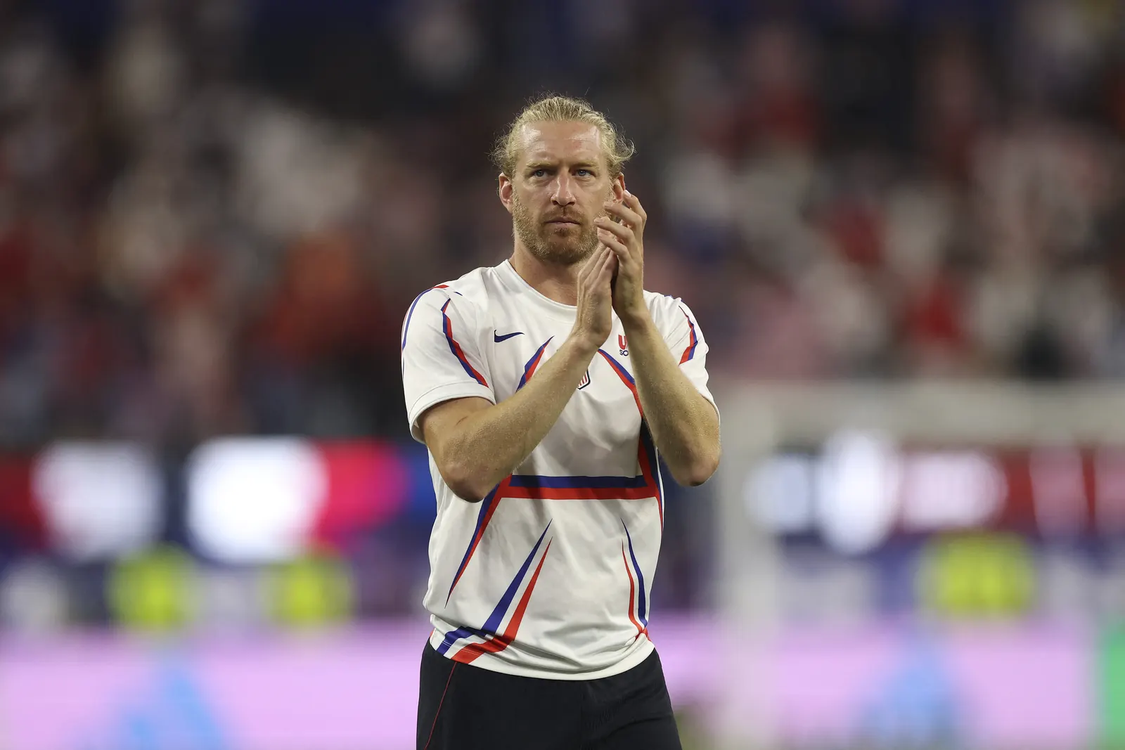 A football player in a US national team kit during a FIFA World Cup match.
