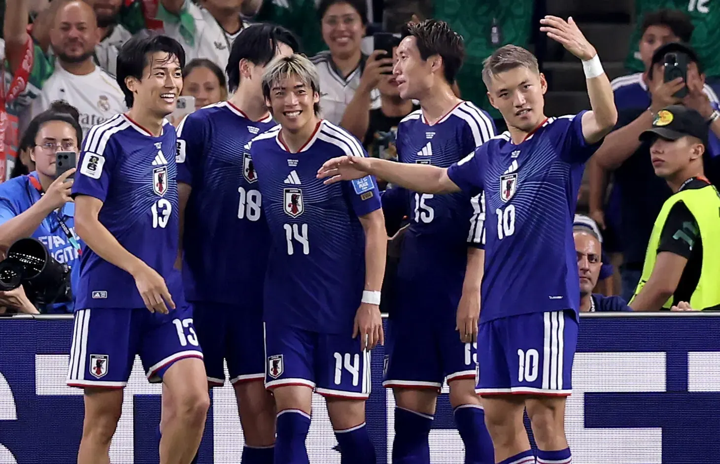 Japanese players celebrate a goal against Tunisia during their FIFA World Cup match.