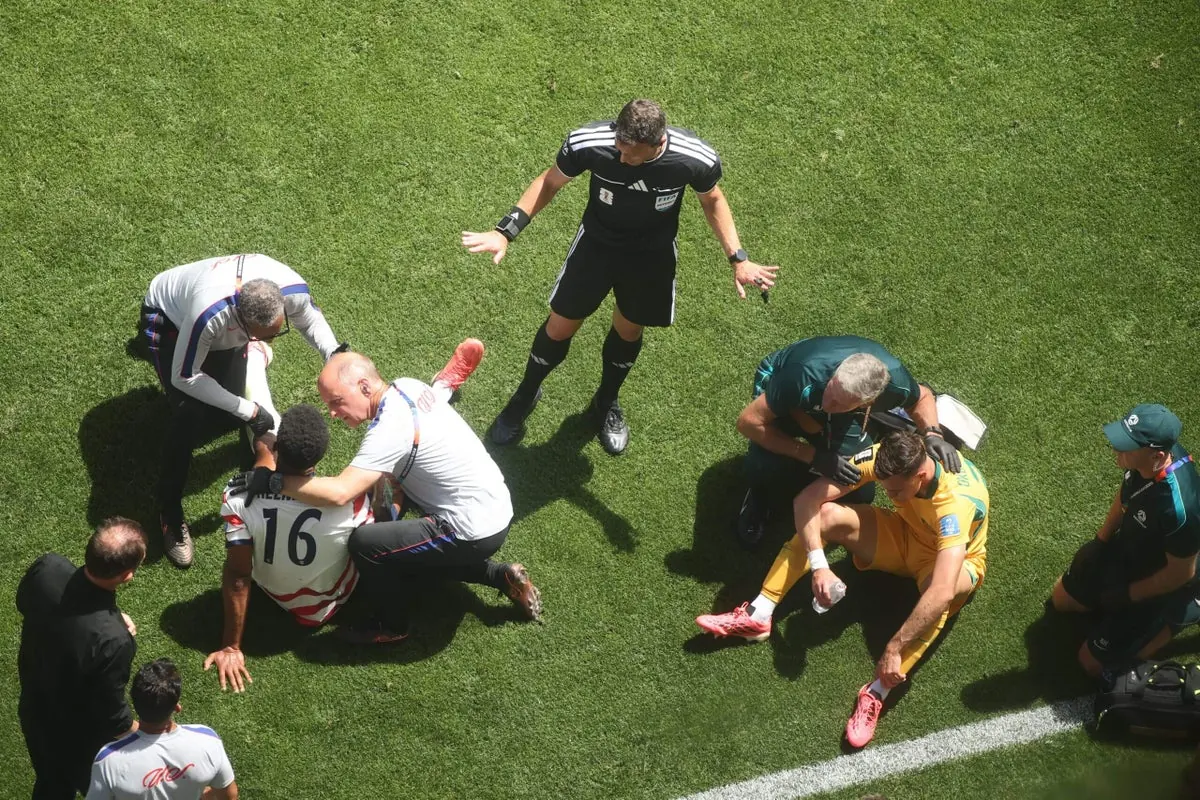 U.S. defender Alex Freeman is attended to by medical staff after a head clash during a World Cup match.